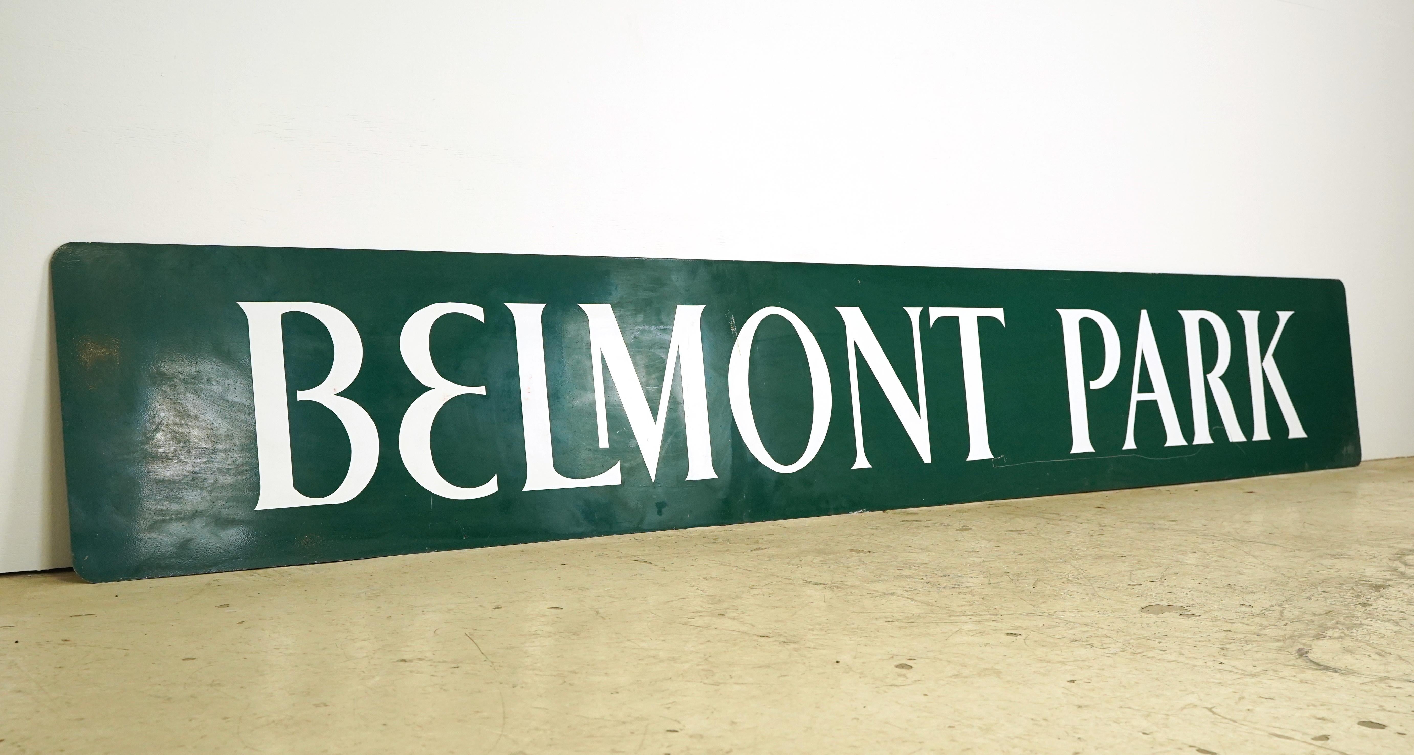 This aluminum sign was acquired from the Belmont Park racetrack in Elmont, New York. The large rectangle shaped sign is dark green with white lettering displaying 