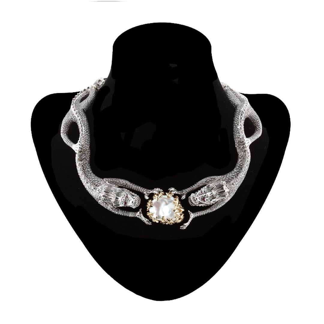 Oxidized sterling silver 1300 one- point, full-cut white diamonds 13.00ct. Rubies. Green diamonds. Baroque Pearl measuring 32 x 24 MM set in 18k gold. 

The flexibility and comfort of this statement piece adds to the pleasure of sharing the evident