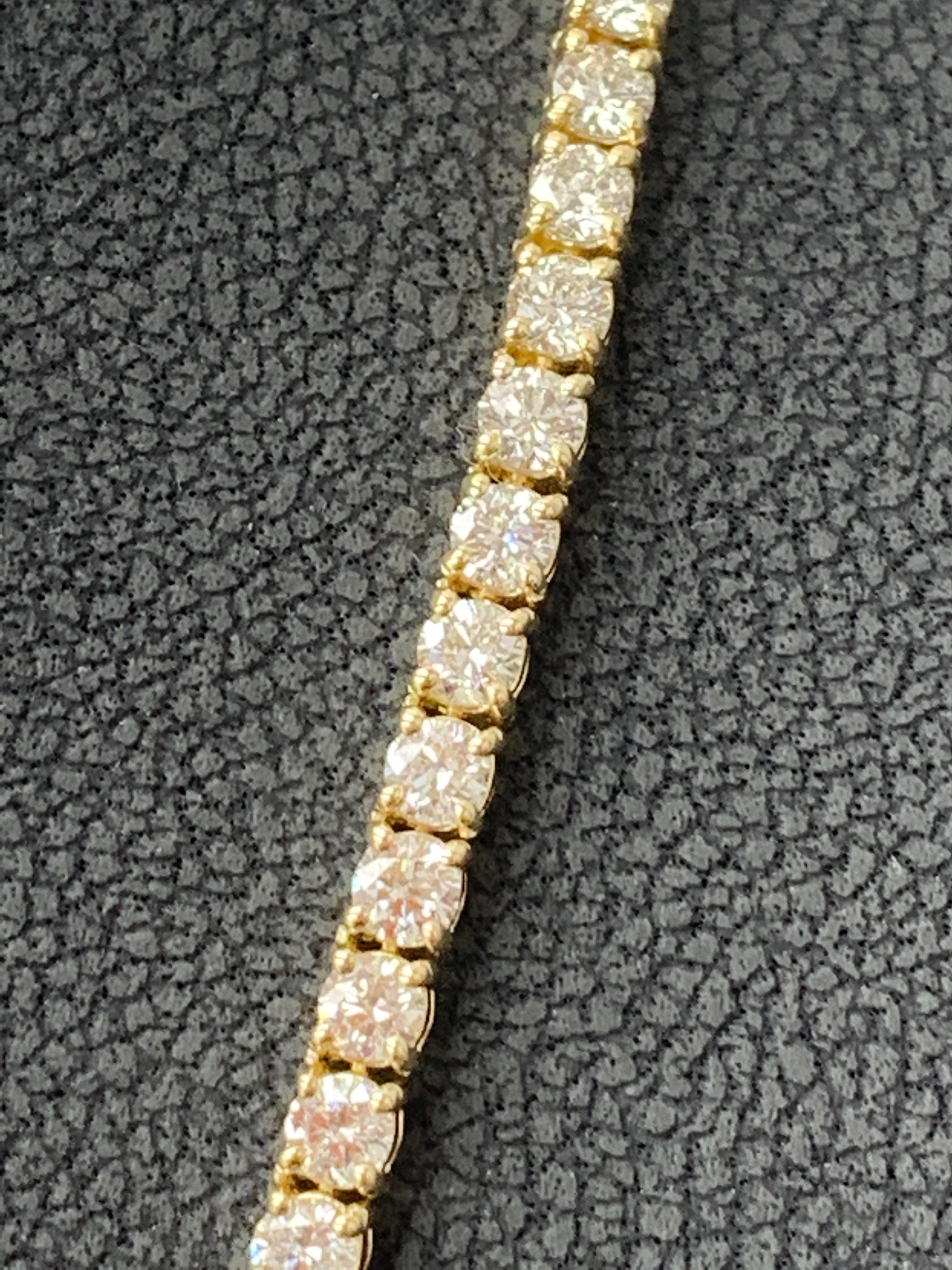 A brilliant and classic piece showcasing a line of round diamonds set in 14K Yellow Gold. 131 diamonds in this necklace are brilliant round cut and weigh 13.01 carats total. 16 inches in length.