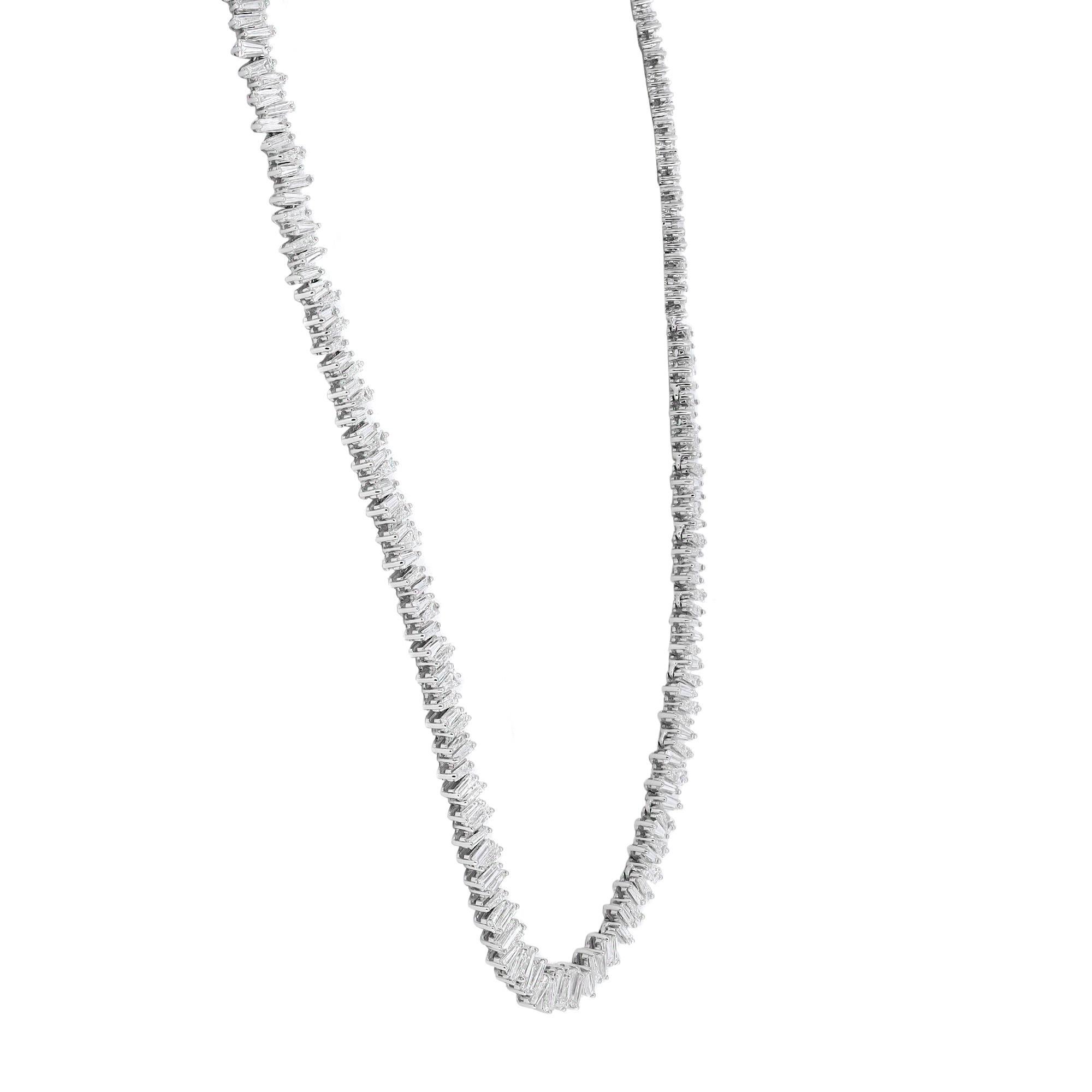 Elegant and alluring, this diamond tennis statement necklace features prong set Baguette Cut shimmering white diamonds weighing 13.02 carats in total. Crafted in fine 18k white gold. The necklace is secured by a hinged locking clasp. Length: 16