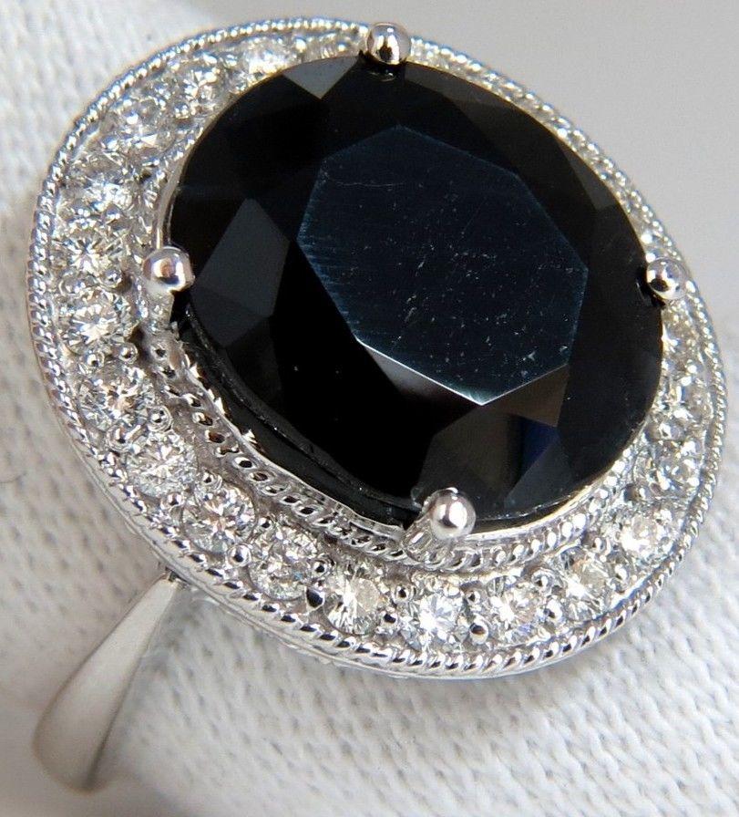 Fade to Black.

12.26ct. Natural Black Sapphire diamonds ring.

Fully faceted oval cut brilliant

.56 X .48 inch.



Side Round, full cut diamonds:

.78ct. 

G colors, Vs-2 clarity.



14Kt. White gold.

9 Grams

Deck of ring:

Deck of ring: .82 X