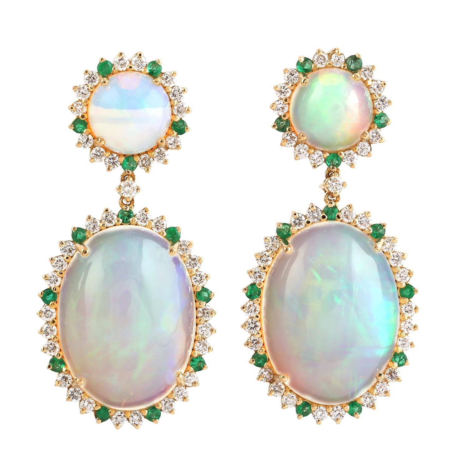 Cast in 14 karat gold. These earrings are hand set in 13.05 carats Ethiopian opal, .34 carats emerald, and .82 carats of sparkling diamonds. 

FOLLOW MEGHNA JEWELS storefront to view the latest collection & exclusive pieces. Meghna Jewels is proudly
