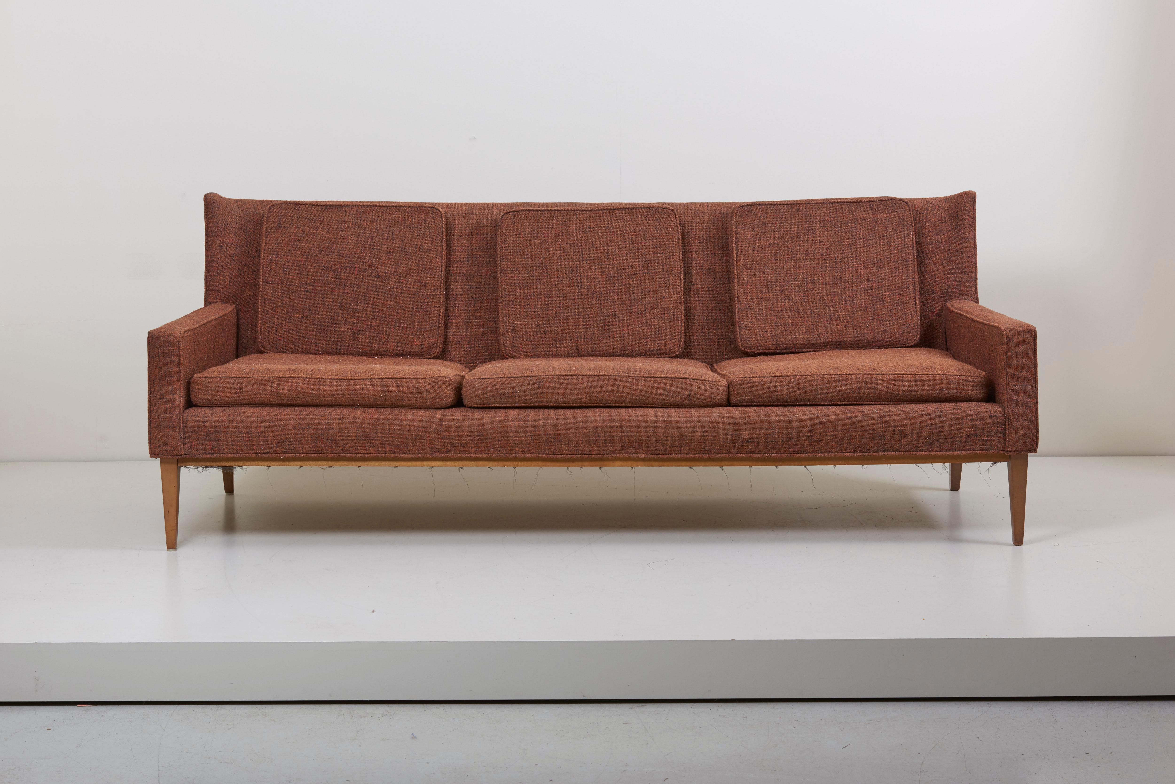 Paul McCobb sofa model 1307 for Directional features a slight winged back resting on a maple frame that gives the sofa a floating look with loose cushions on seat and back.

Upholstery needed, could be done in our own upholstery workshop,