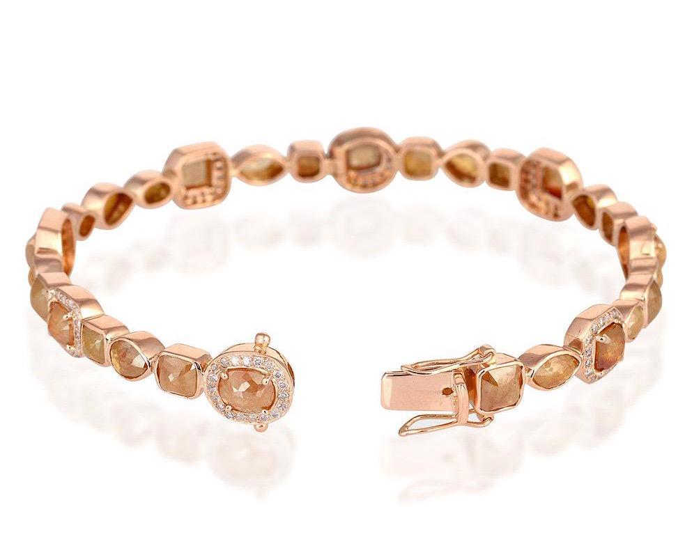 This eternity bracelet is cast in 18k rose gold featuring 13.08 carats of fancy diamonds. A button closure with a hinged lock.

Composition
Size-68X58X8 MM
Total Weight-20.24
Gold Weight(Gms)-17.624
Diamond Wt(Cts)-13.08