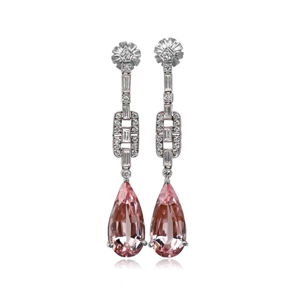Elevate your elegance with these hanging earrings showcasing pear-shaped natural pink morganites. Weighing a combined 13.09 carats, each morganite is delicately secured in prongs, suspended by a stylish geometric arrangement adorned with baguette
