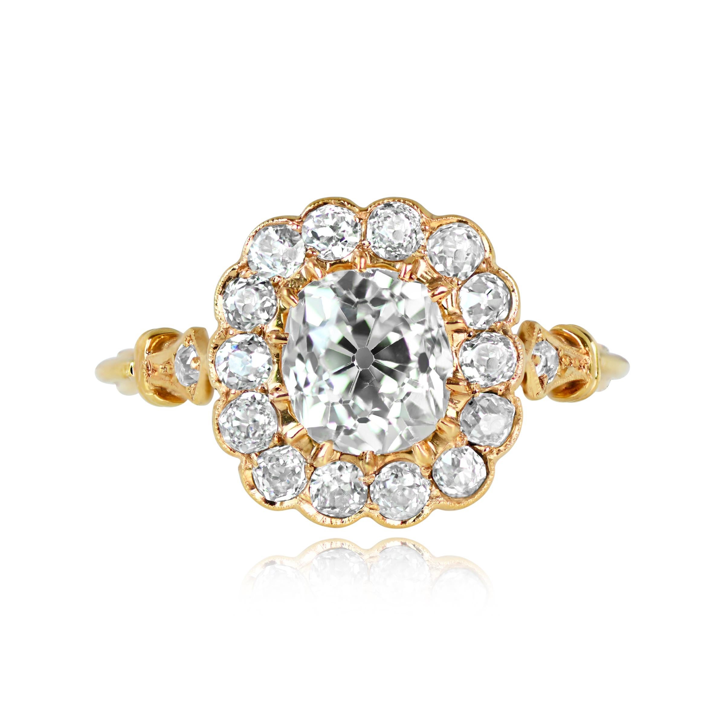 A captivating cluster engagement ring showcases a vibrant antique cushion cut diamond, around 1.30 carats, with K color and VS1 clarity. An ensemble of old mine-cut diamonds forms a delightful cluster around the center stone, totaling approximately
