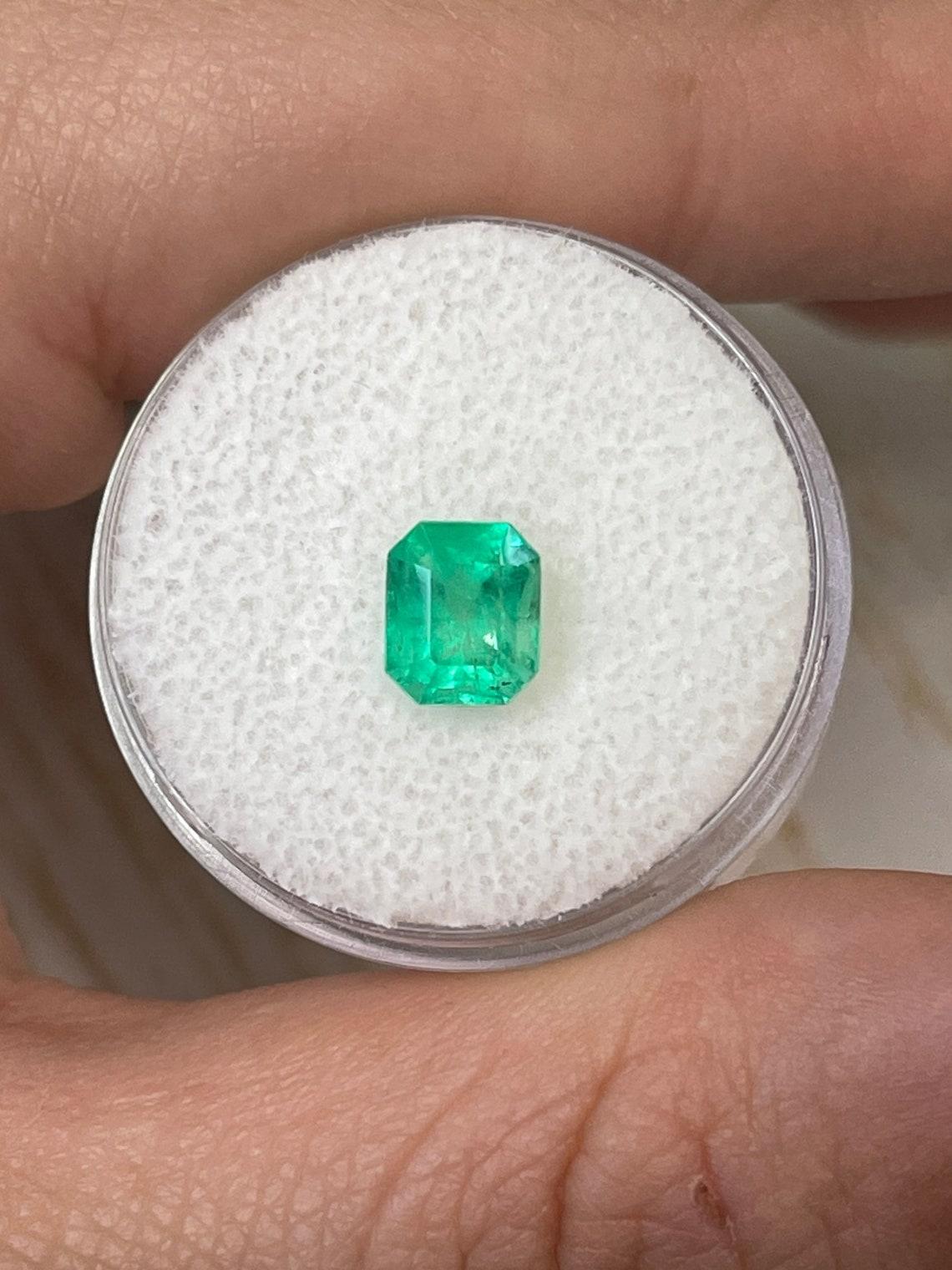 Stone: Emerald
Weight: 1.30-carats
Shape: Emerald Cut
Clarity: Transparent
Luster: Very Good
Color: Yellowish Green
Measurements: 6.93mm x 5.92mm x 5.23mm
Geographic Origin: Colombia
Treatment: Natural, Oiling

Comments: Due to their growth