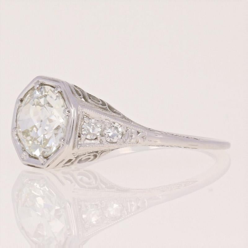 Watch your sweetheart’s eyes sparkle when you propose with the ring of her dreams! Dating back to the 1920s - 1930s, this Art Deco engagement piece hosts a stunning European cut diamond solitaire outlined by an octagonal-shaped frame and held in an
