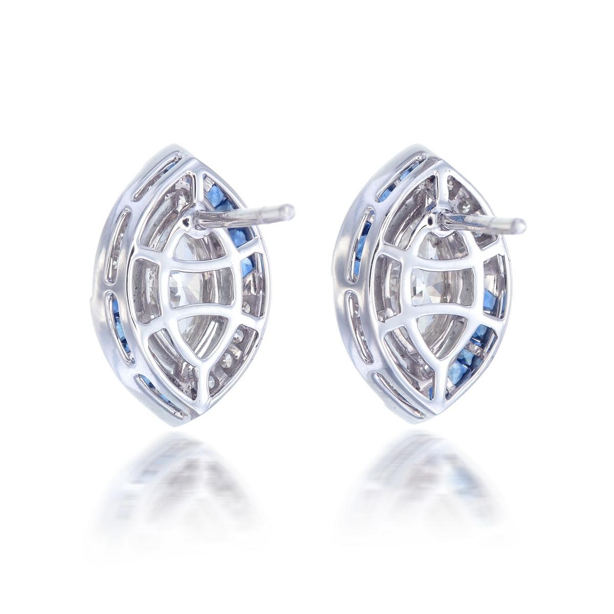 A new pair of diamond and blue sapphire earrings inspired by art-deco themes made in 18 Karat White Gold. 

The two center marquise diamonds weigh approximately 1.31 carats total, with the sixteen supporting round diamonds weighing approximately