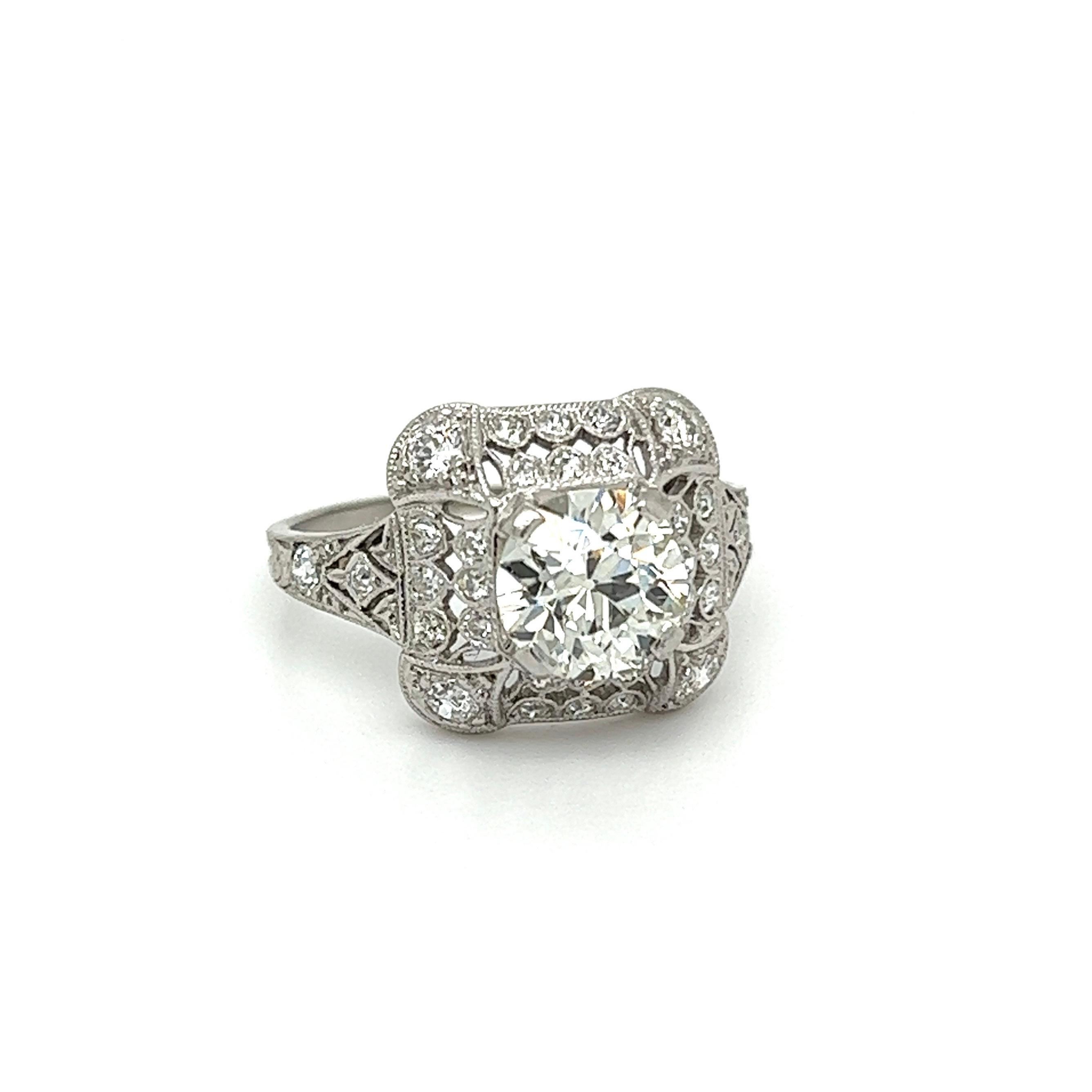 Simply Beautiful! Finely detailed Vintage Art Deco OEC Diamond Solitaire Platinum Ring. Centering a securely nestled Hand set Old European Cut Diamond, weighing approx. 1.31 Carats. H/I Color, VS2 Clarity. Surrounded by Diamonds weighing approx.