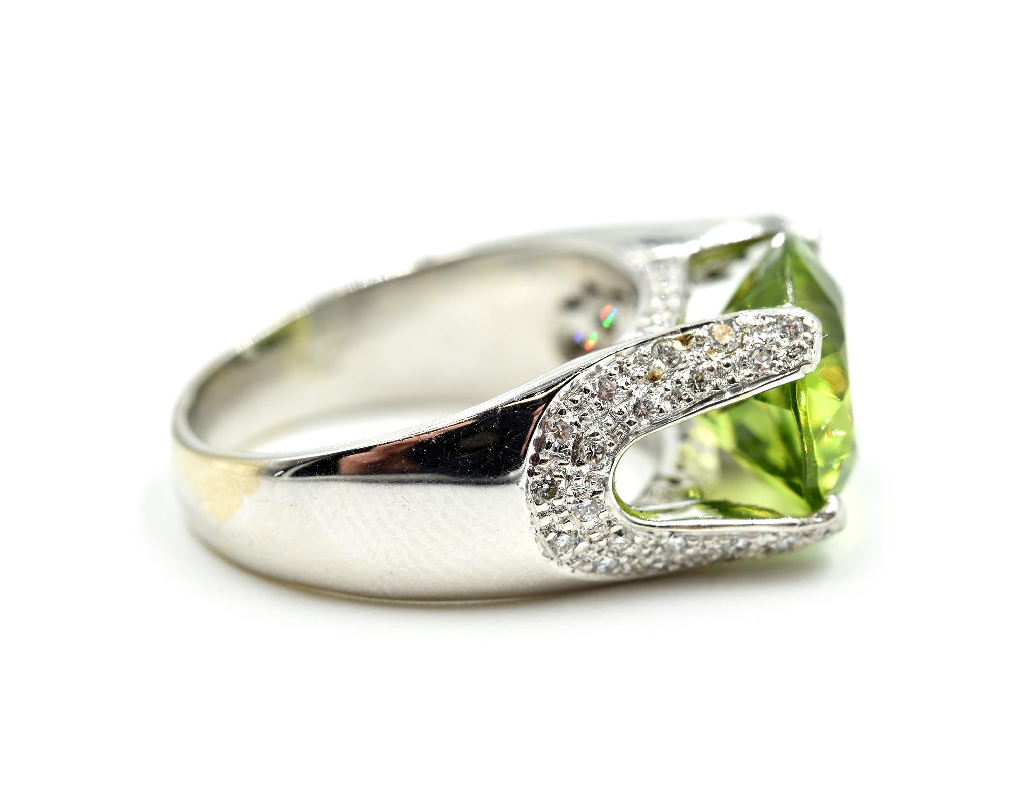 Designer: custom design
Material: 18k white gold
Peridot: 1.31 carat oval cut peridot gemstone
Diamonds: 42 round brilliant cuts = 0.21 carat total weight
Dimensions: band is 1/2 inch long
Ring Size: 5 ½ 
Weight: 8.00 grams
