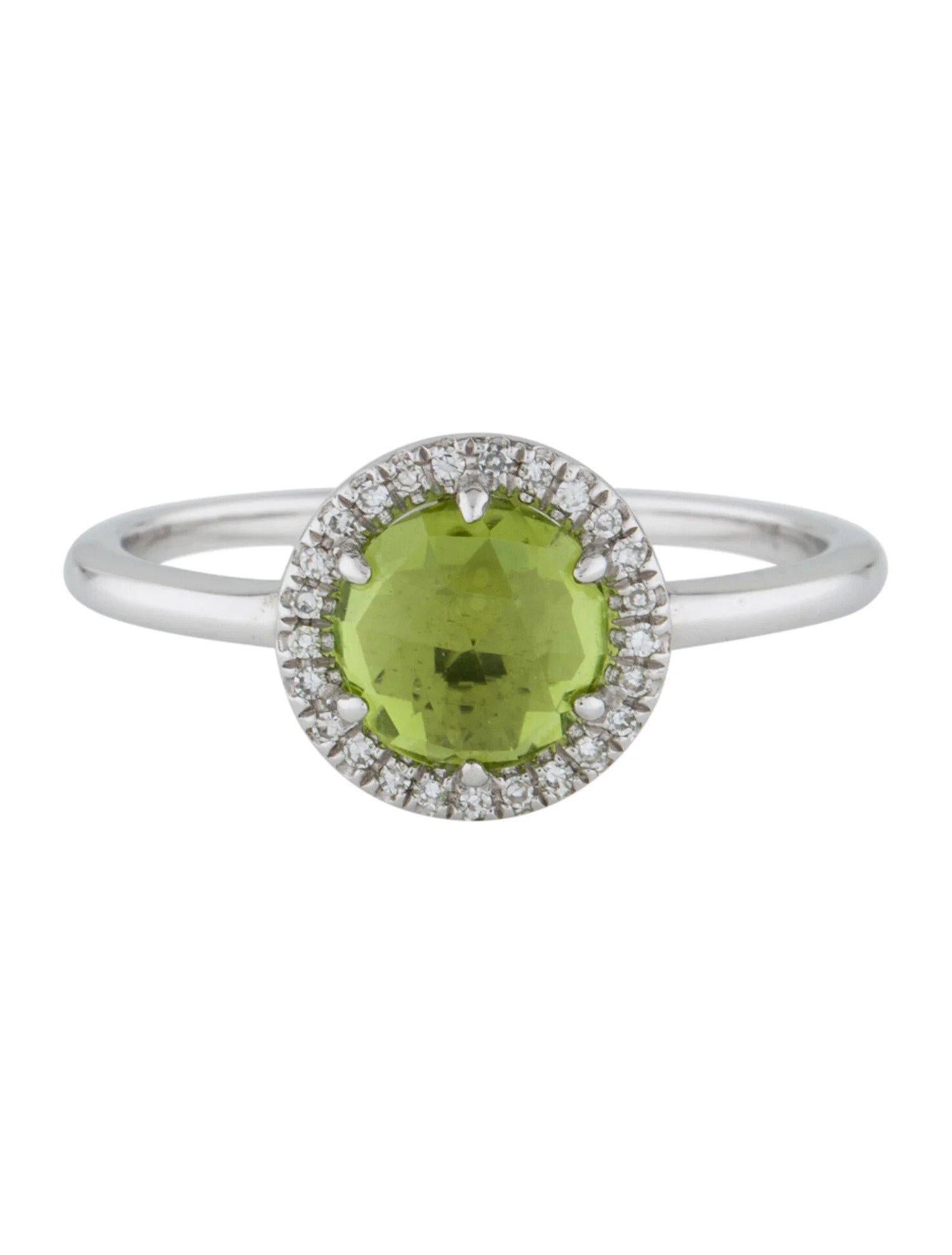 This Peridot & Diamond Ring is a stunning and timeless accessory that can add a touch of glamour and sophistication to any outfit. 

This ring features a 1.31 Carat Peridot, with a Diamond Halo comprised of 0.06 Carats of Single Cut Round White