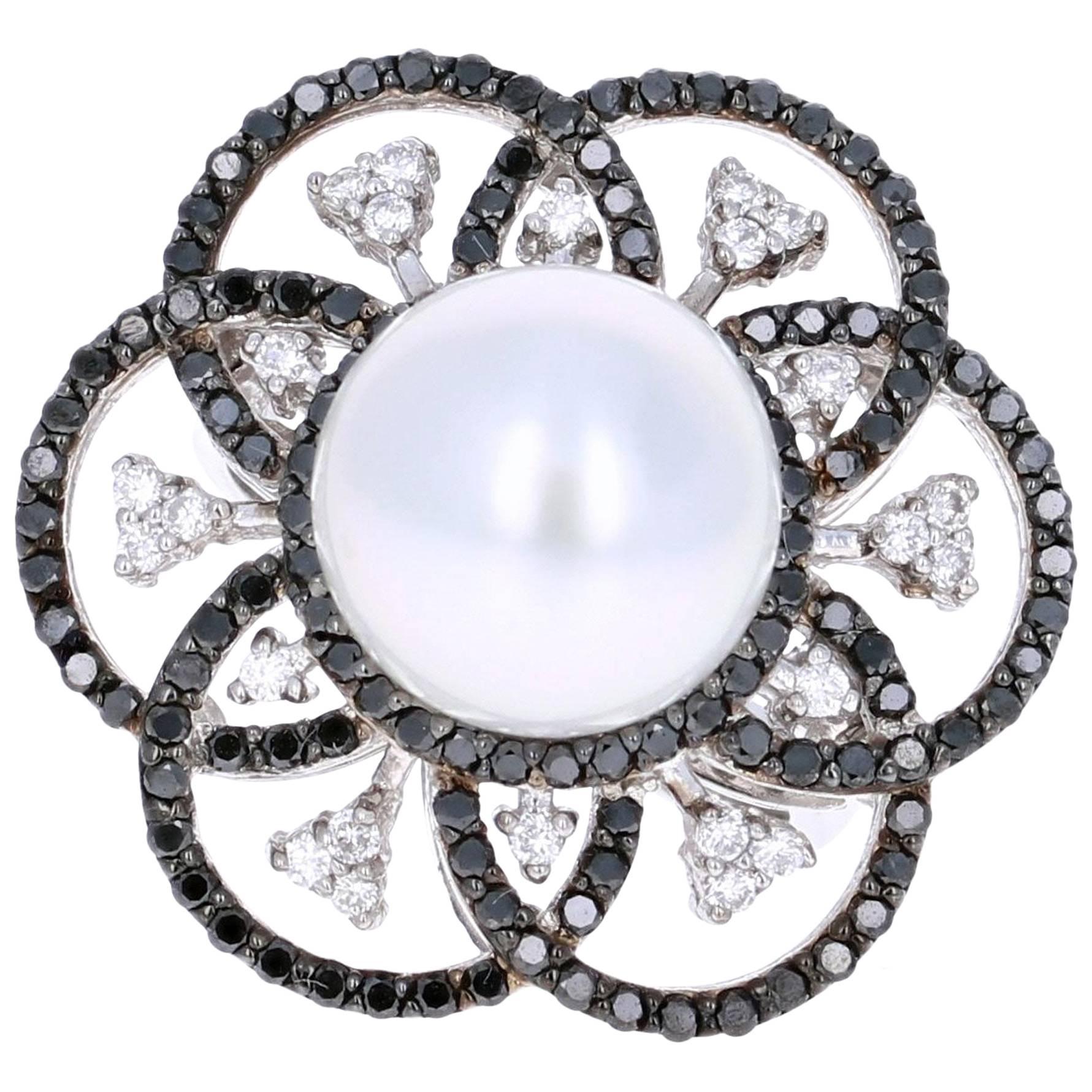 A Gorgeous 1.31 carat South Sea Pearl, Black and White Diamond Cocktail ring that is sure to elevate your look! There is a beautiful South Sea Pearl in the center of the ring followed by petal like alternating black and white diamonds that are set