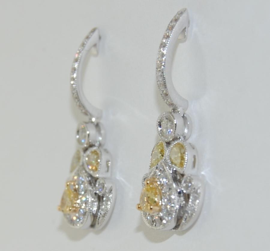 Features Pear Shaped Fancy Diamond/Yellow Earrings, with Brilliant Cut Round White Diamonds total weight 1.31 Carats, made in 18 Karat White Gold.  Length 1 inch.