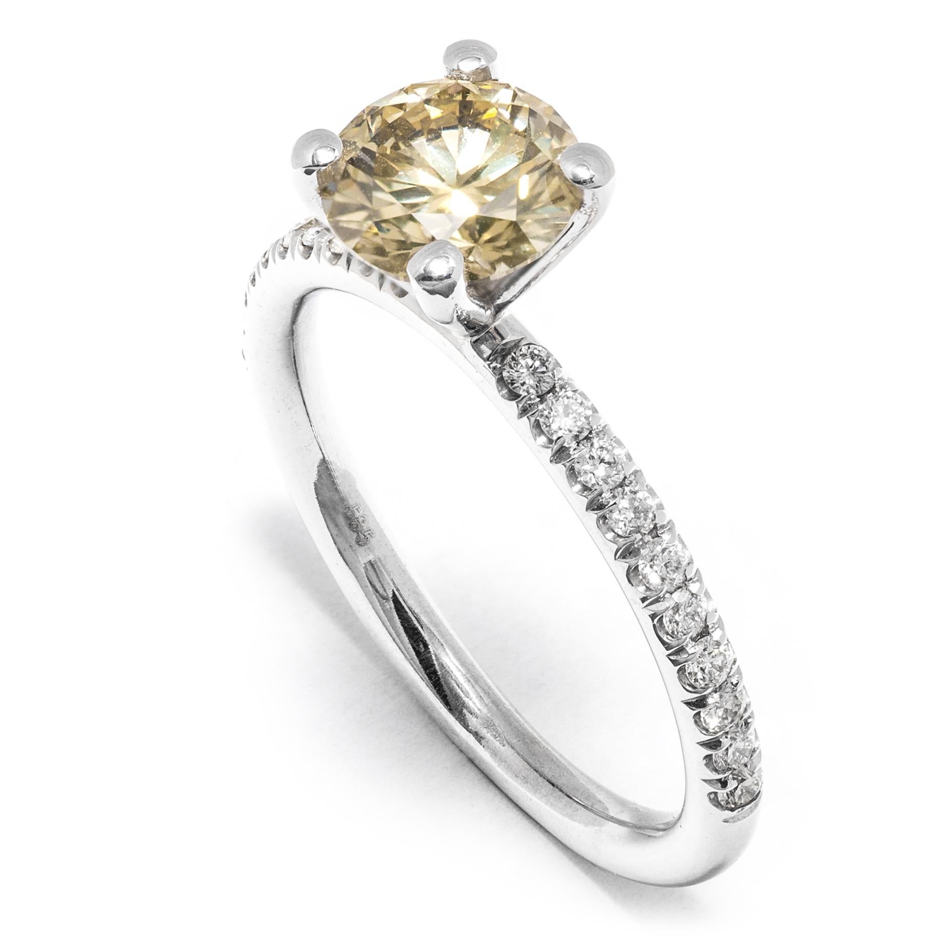 This item is offered without any reserve price, starting bid $1, highest bid wins.
Modern and elegant ring set with 1.31 ct Natural Brownish Yellow Round Brilliant Diamond at the center of a 14k White Gold frame accented by a pave of 0.24 ct (20)