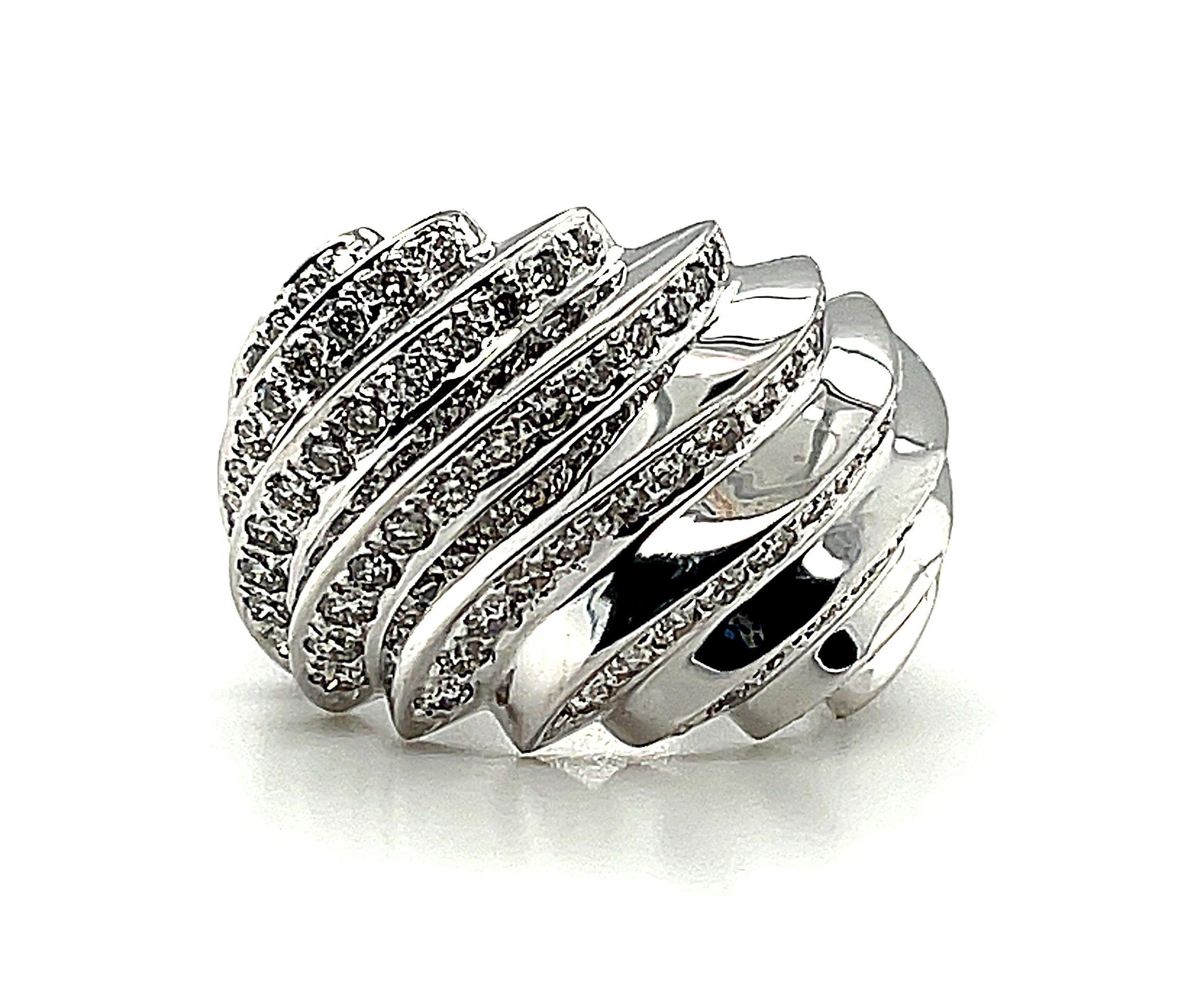The cascading ridges of pave set diamonds on this gorgeous dome ring create a truly eye-catching visual effect! Set with 92 round brilliant cut diamonds, this bold 18k white gold this ring is stunning and fun to wear. It has a distinctive Art Deco /