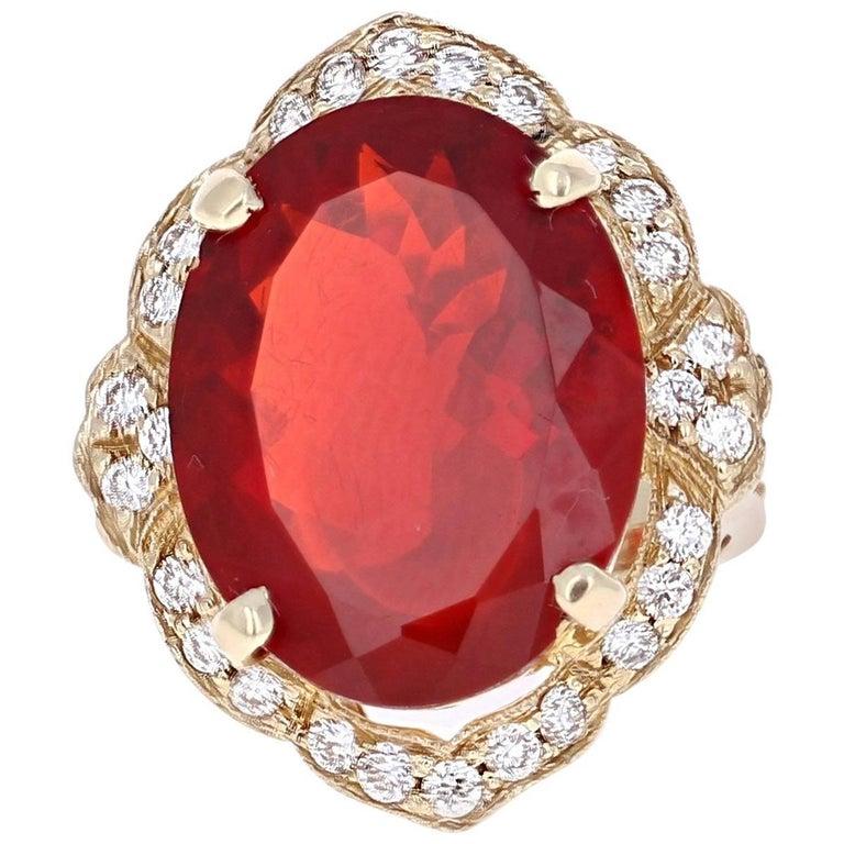 Bright, Beautiful and Bold! 

This gorgeous Victorian inspired cocktail ring has a large beautiful Oval Cut Fire Opal that weighs 12.25 carats and 28 Round Cut Diamonds that weigh 0.86 carats. The clarity and color of the diamonds are VS2-H.  The