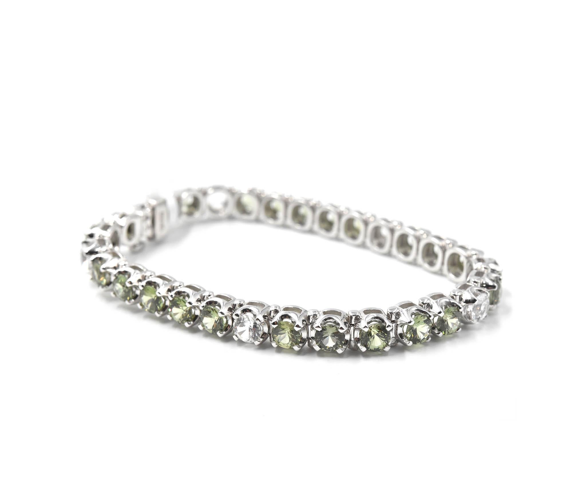 Designer: custom design
Material: 18k white gold
Green Sapphires: 10.97 carat weight
White Sapphires: 2.16 carat weight
Total Carat Weight: 13.13
Dimensions: bracelet is 7-inch long
Weight: 27.92 grams
