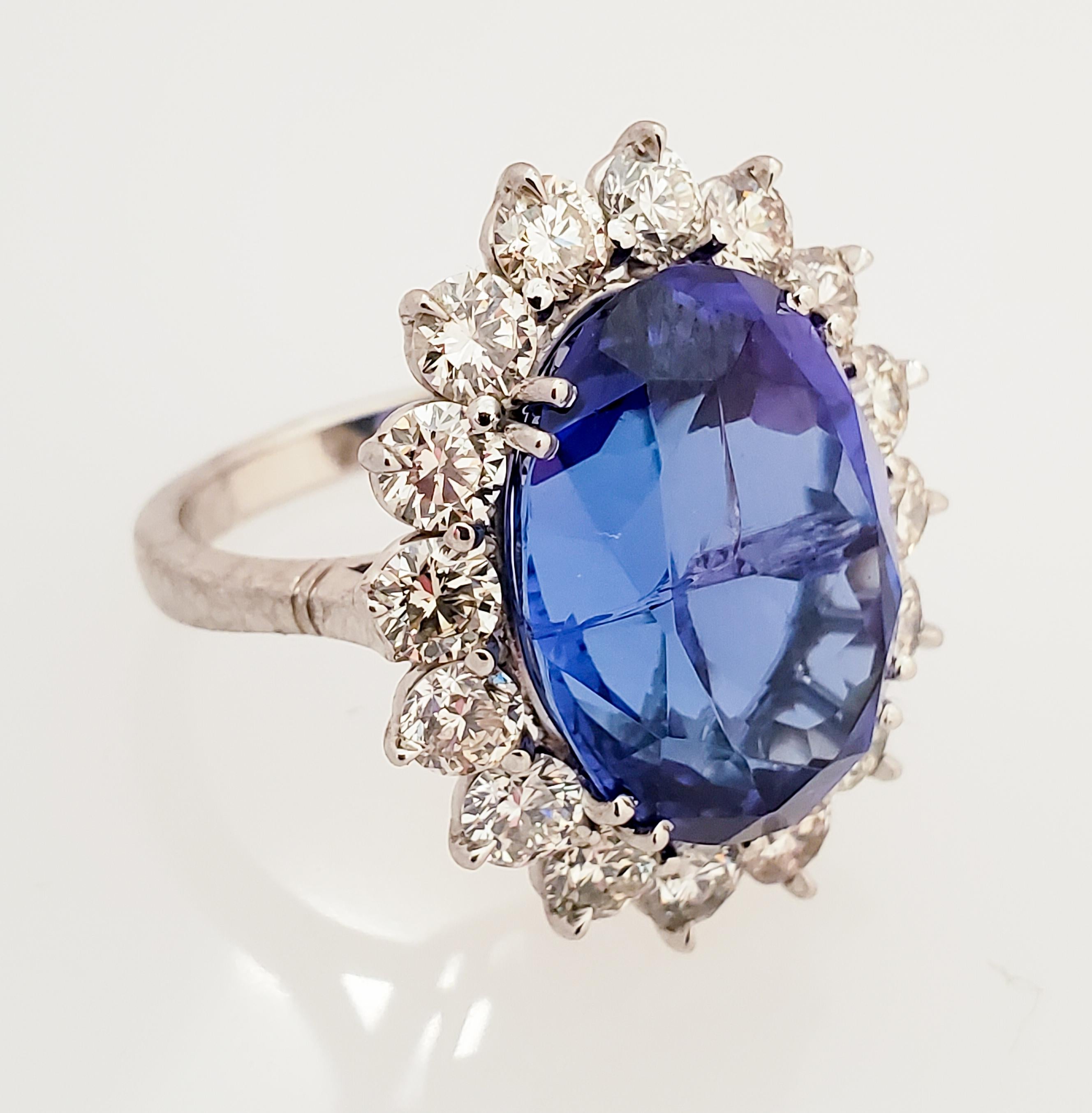 This is a 13.14 carat oval cut fine quality intense bluish-violet tanzanite in a secure double prong setting. The gem source is near the foothills of Mt. Kilimanjaro in Tanzania. Its color is vivid and vibrant; its transparency and luster are
