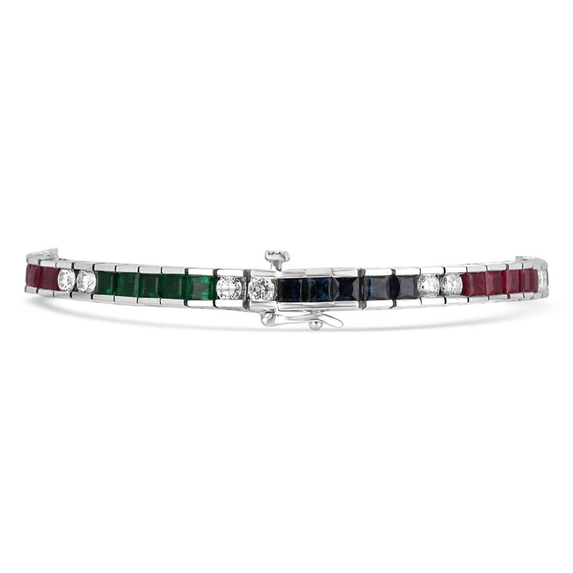 Showcased is an exquisite fine gemstone, blue sapphire, ruby, emerald, and diamond tennis bracelet with a grand total of 13.17tcw. Princess cut gemstones and brilliant round diamonds are channel set in this bracelet creating an alluring array of