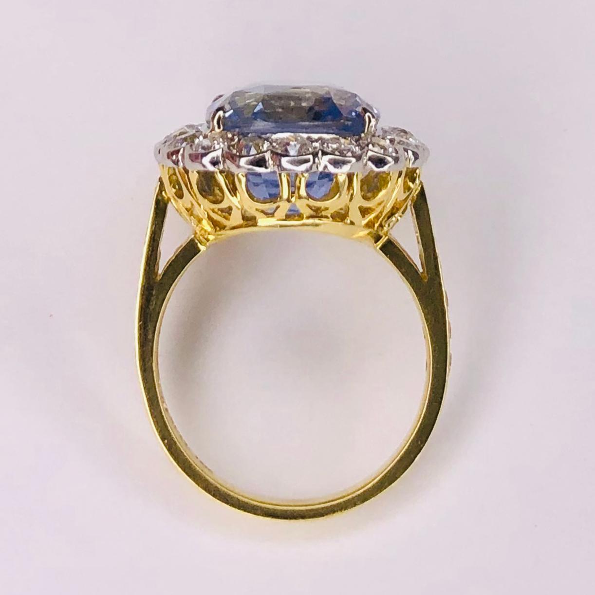 Elegant & finely detailed Vintage Ring, center set with a securely nestled 13.18 Carat Sapphire NO HEAT surrounded by 19 round Brilliant cut Diamonds weighing approx. 1.50 total Carat weight ; Hand crafted in Platinum on 18K Yellow Gold. The ring
