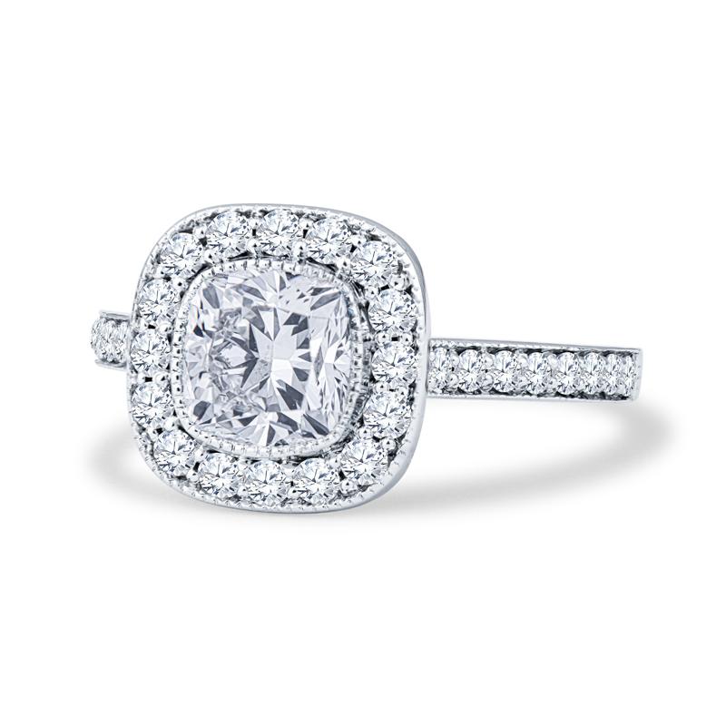 This engagement ring features a 1.31ct cushion cut natural diamond (F SI2, GIA 2186094350, inscribed), set in a 14kt white gold diamond halo engagement ring surrounded with 0.75ctw in round accent diamonds. The ring itself is a size 6, but can be