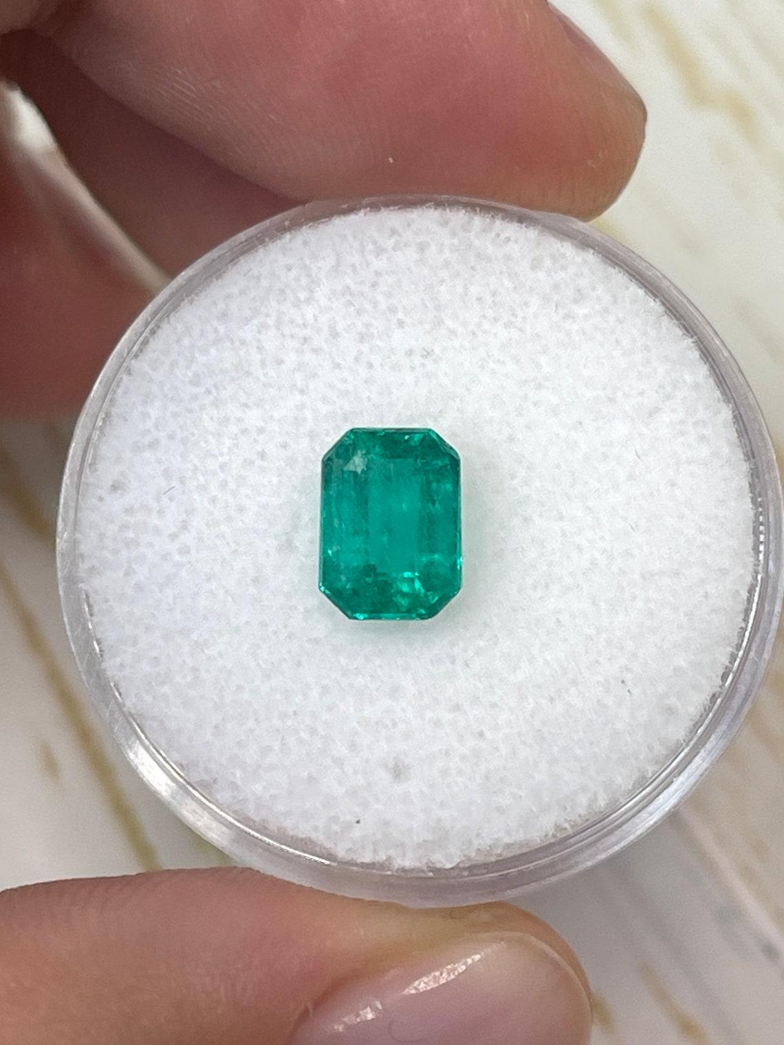 Stone: Emerald
Weight: 1.31-carats
Shape: Emerald Cut
Clarity: Transparent
Luster: Very Good
Color: Bluish Green
Measurements: 7.74mm x 5.65mm x 4.36mm
Geographic Origin: Colombia
Treatment: Natural, Oiling

Comments: Due to their growth conditions