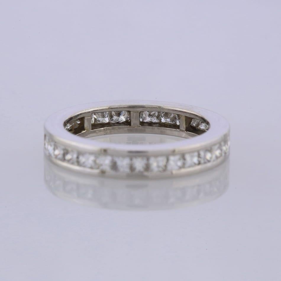 This is an 18ct white gold diamond full eternity ring. The ring plays host to 29 channel set princess cut diamonds that cover the whole band of the ring.

Condition: Used (Excellent)
Weight: 6.3 grams
Size: N
Band Width: 3.5mm
Total Diamond Carat