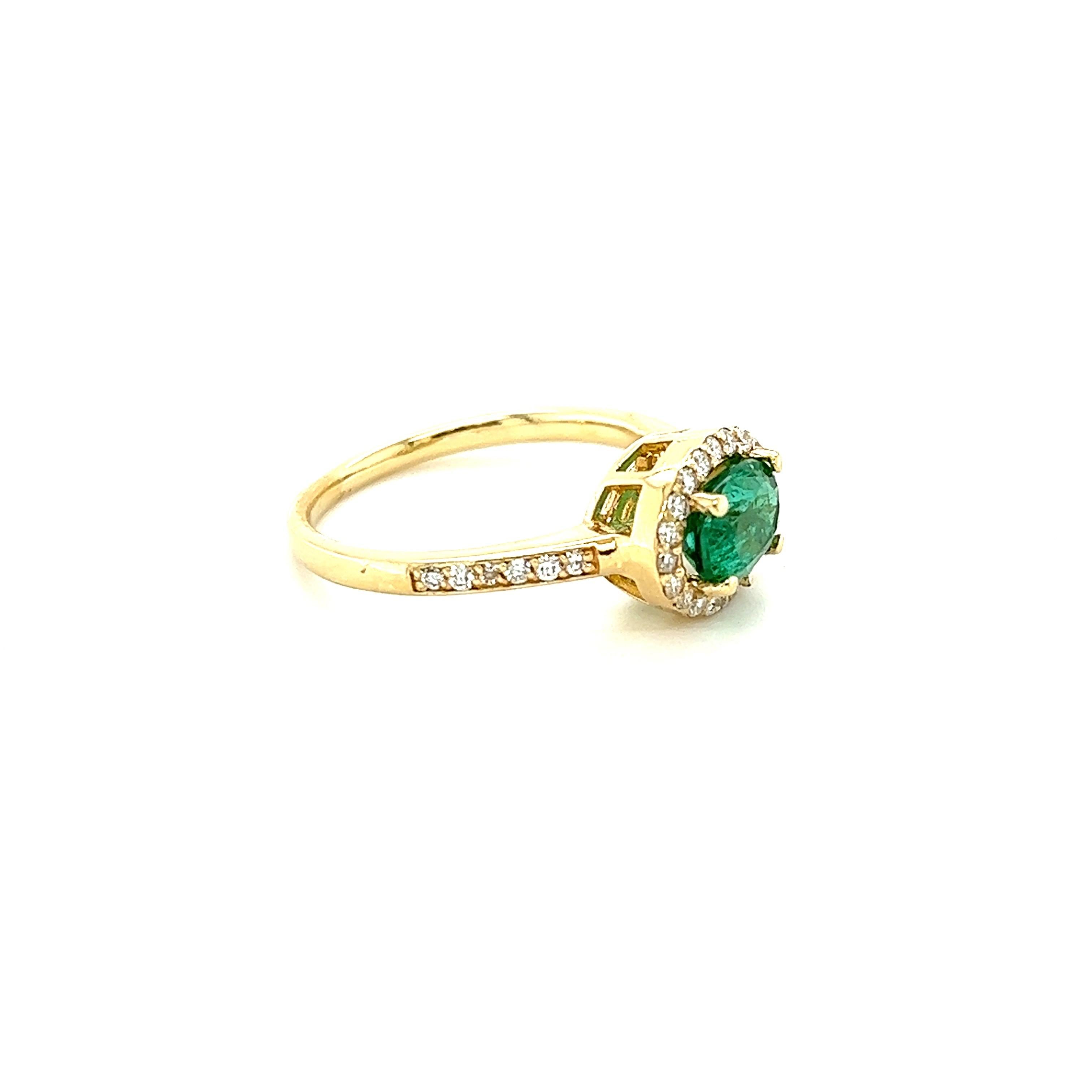 This ring has a 1.00 Carat Oval Cut Emerald and is surrounded by 32 Round Cut Diamonds that weigh 0.32 Carats. (Clarity: VS, Color: H) The total carat weight of the ring is 1.32 carats. 
The Oval Cut Emerald measures at approximately 7 mm x 5 mm.