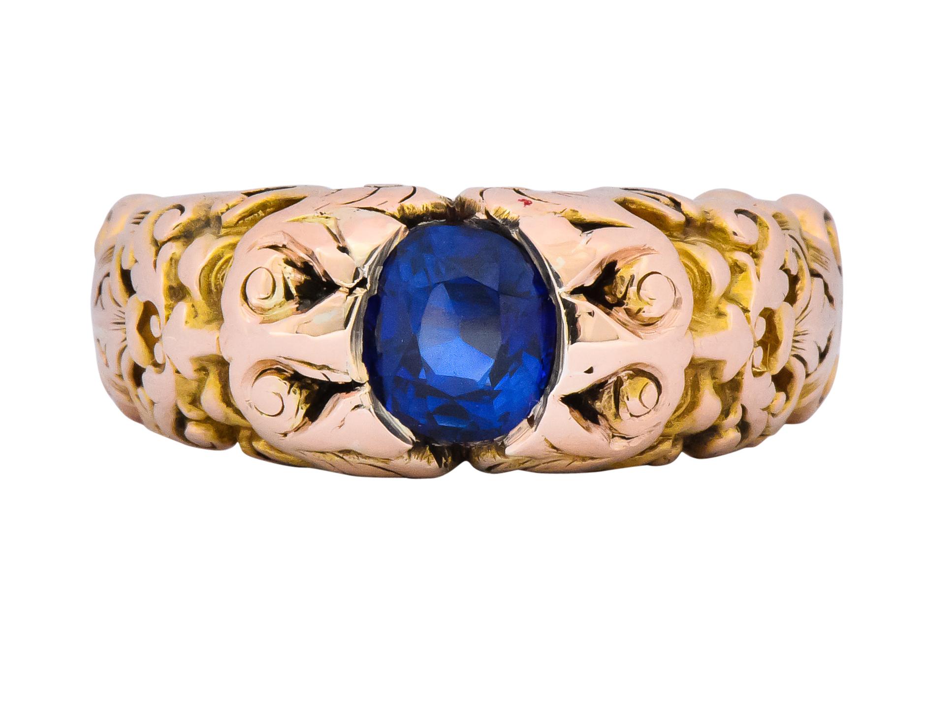Centering an oval cut sapphire weighing 1.32 carats, bright blue with no evidence of heat treatment

Partial bezel setting

With incredibly detailed mount depicting Anemoi, the god of wind on both sides

Deeply engraved gold with pierced, scrolling