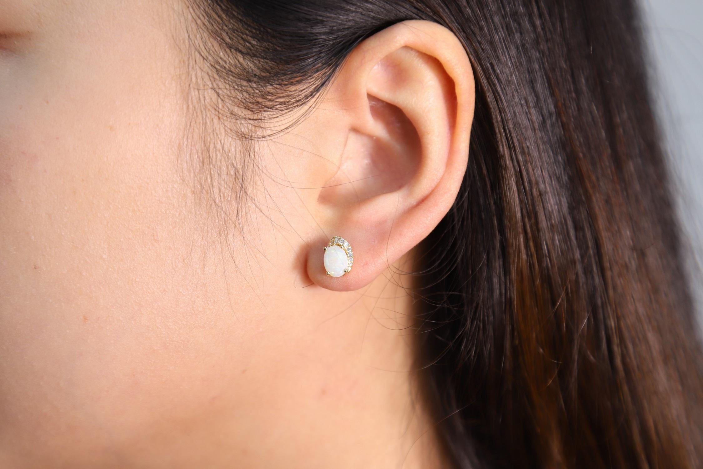 Decorate yourself in elegance with this Earring is crafted from 10K Yellow Gold by Gin & Grace Earring. The jewelry boasts 5X7 Oval-Cut cabochon setting white color Natural Opal (2 pcs) 1.32 Carat and Round-Cut prong setting Diamond (24 pcs) 0.11