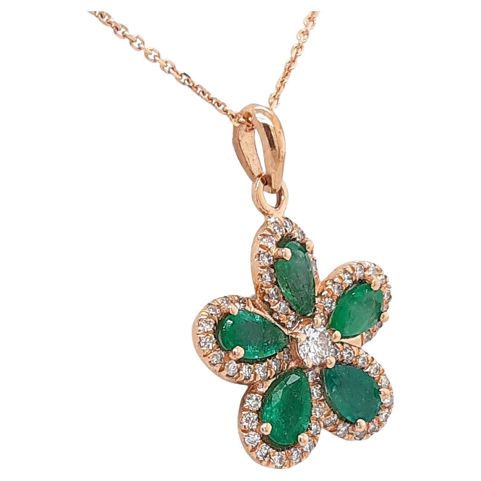 FOR U.S. BUYERS NO VAT 

This unique 14kt pink gold flower pendant features 5 intense green emeralds with a total of 1.00-carat weight surrounded by 56 round brilliant diamonds, totaling 0.32 carats. Each diamond is placed perfectly to create a