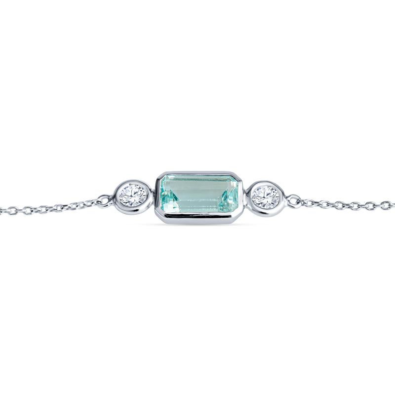 This elegant bracelet features a 1.32 carat emerald cut bezel set aquamarine set in 14 karat white gold. It is beautifully complemented by two bezel set round diamonds totaling 0.23 carats, perfect for women who appreciate sophisticated designs.