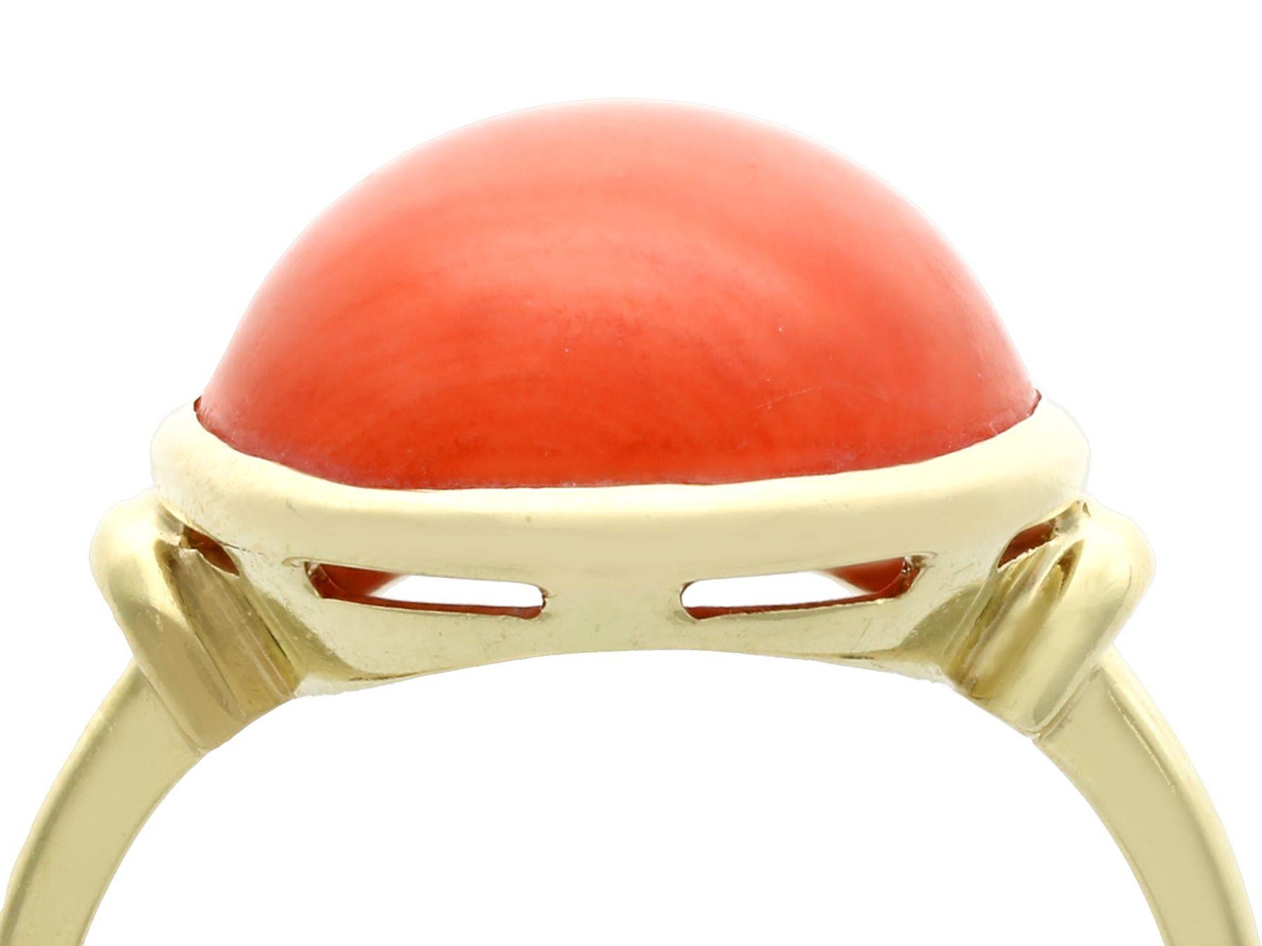 A fine and impressive vintage 13.20 carat coral and 14 karat yellow gold cocktail ring; part of our diverse gemstone jewelry collections.

This impressive 1950s vintage cabochon cut ring has been crafted in 14k yellow gold.

The simple yet