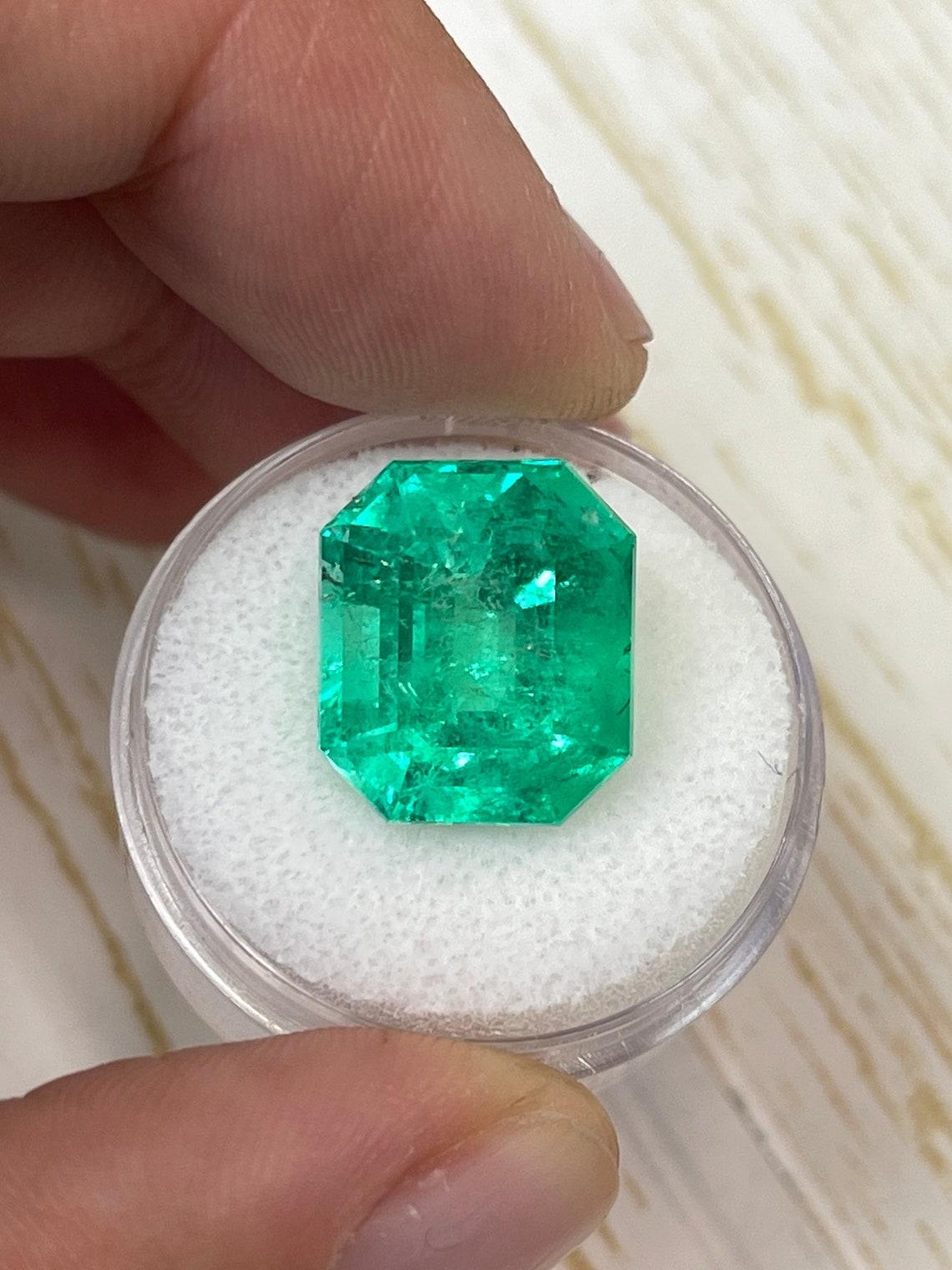 Stone: Emerald
Weight: 13.22-carats
Shape: Emerald Cut
Clarity: Transparent
Luster: Excellent
Color: Muzo Yellowish Green
Measurements: 14.79mm x 12.80mm x 10.75mm
Geographic Origin: Colombia
Treatment: Natural, Oiling

Comments: Due to their growth