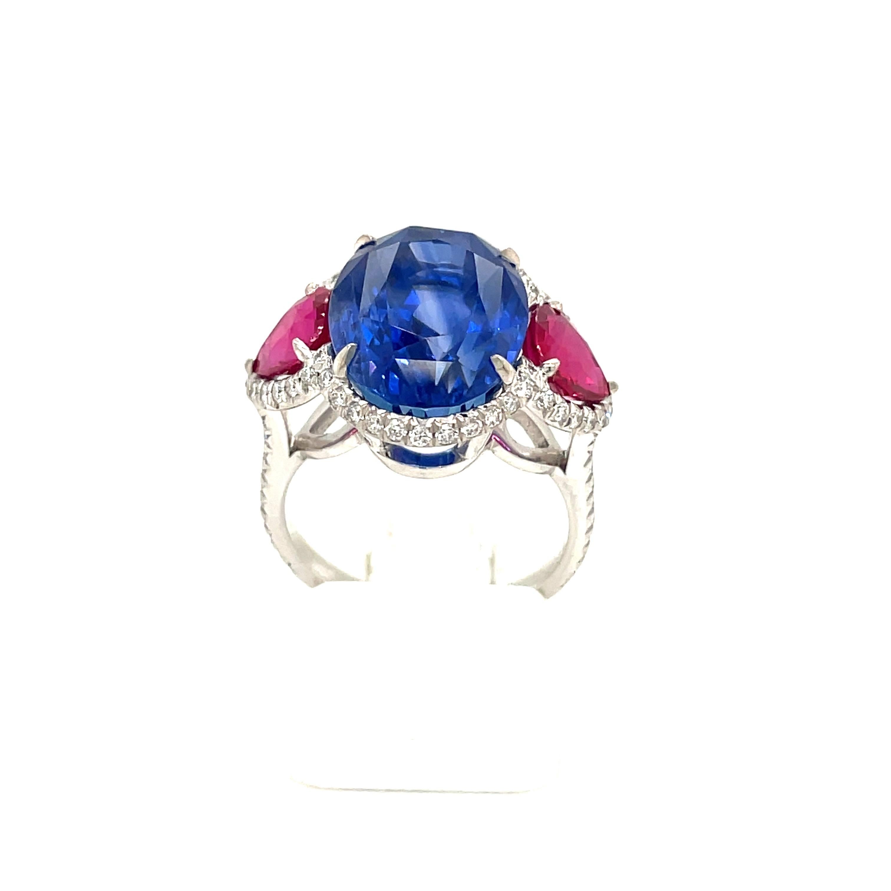 A truly spectacular 13.26 carat Ceylon Sapphire flanked with 2.02 carats of AGL certified Burma Rubies set 18kt white gold in a halo of white diamonds. 