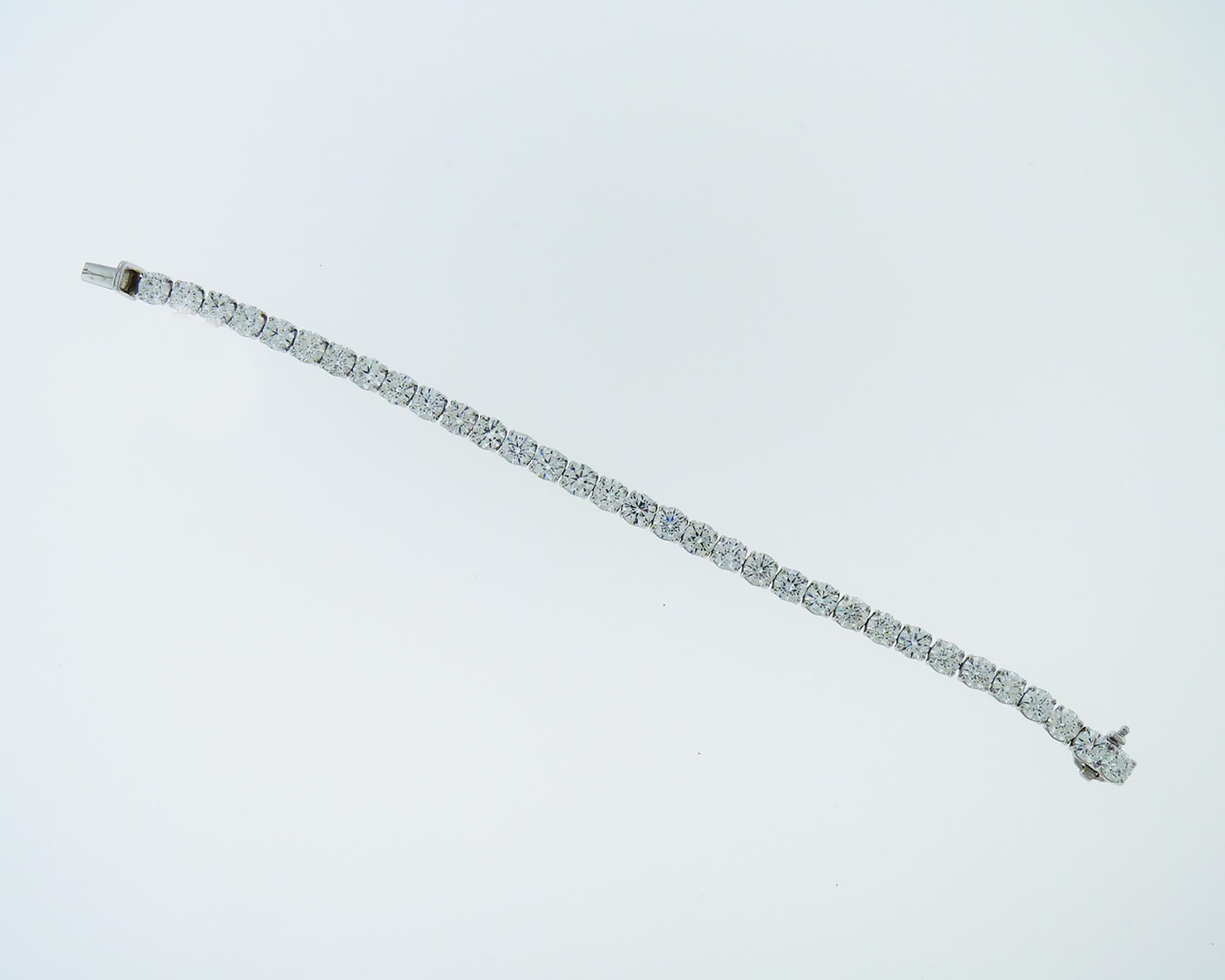 Elegant tennis bracelet embellished with 33 round diamonds, F-G colors, VVS-VS clarity.
Total weight of diamonds is 13.27 carats. 
Weight of the bracelet is 18.32 grams.
Metal is platinum.
Measurements:
L: 6.37 inches (16.2 cm)
W: 0.19 inches (0.5