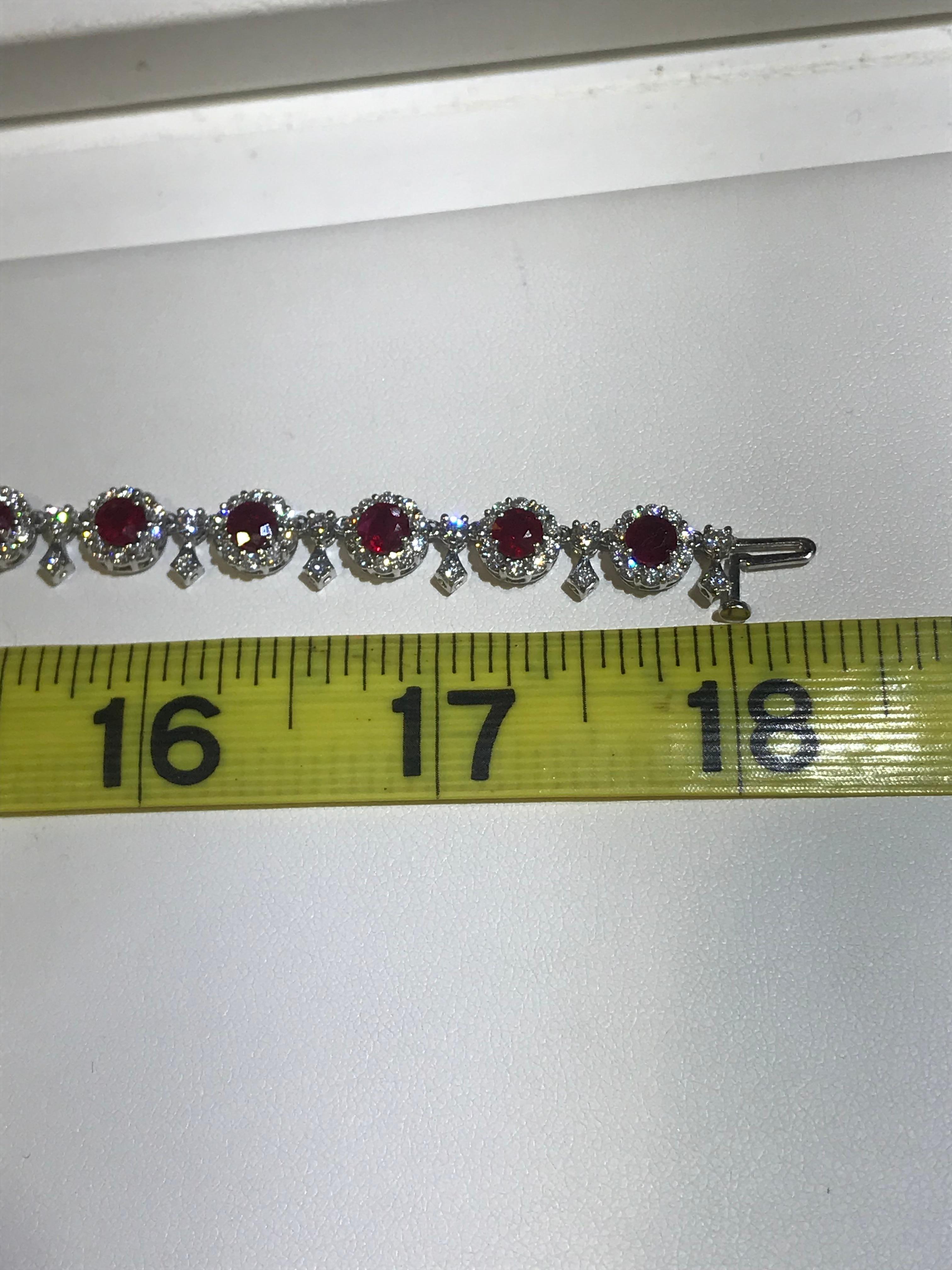 This lovely necklace measures 18 inches and is crafted from 18 karat white gold. It features beautiful, richly colored rubies and sparkling diamonds in the following numbers and measures. 

Rubies: 38 weighing 13.27 carats total weight 
Diamonds: