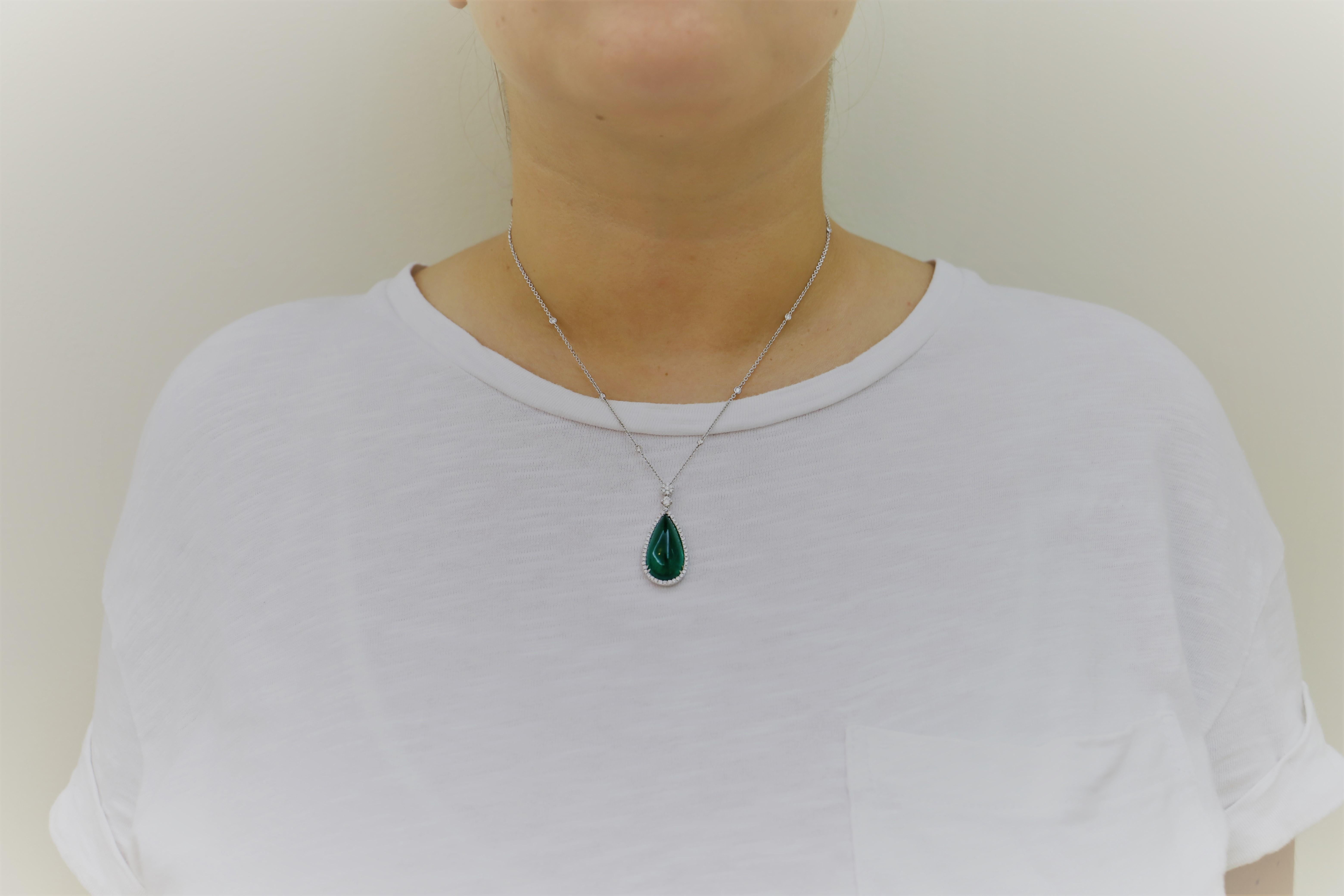 Elegant Pendant Necklaces composed  by 1 Pear Shape Emerald Cabouchon of 13.28 Carat, surrounded by White Diamonds. The Pendants is attached to a White Gold Necklace.
The Necklace has 10 White Diamonds, and it is 16 inches long-with an additional