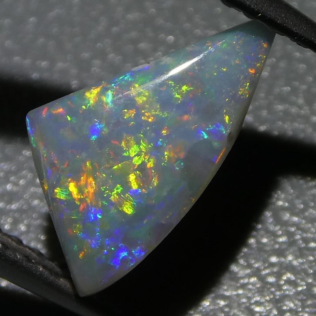 This is a stunning GIA Certified Opal

The GIA report reads as follows:

GIA Report Number: 2215647458
Shape: Freeform Cabochon
Cutting Style:
Cutting Style: Crown:
Cutting Style: Pavilion:
Transparency: Semi-Translucent
Color: Gray
Phenomenon: