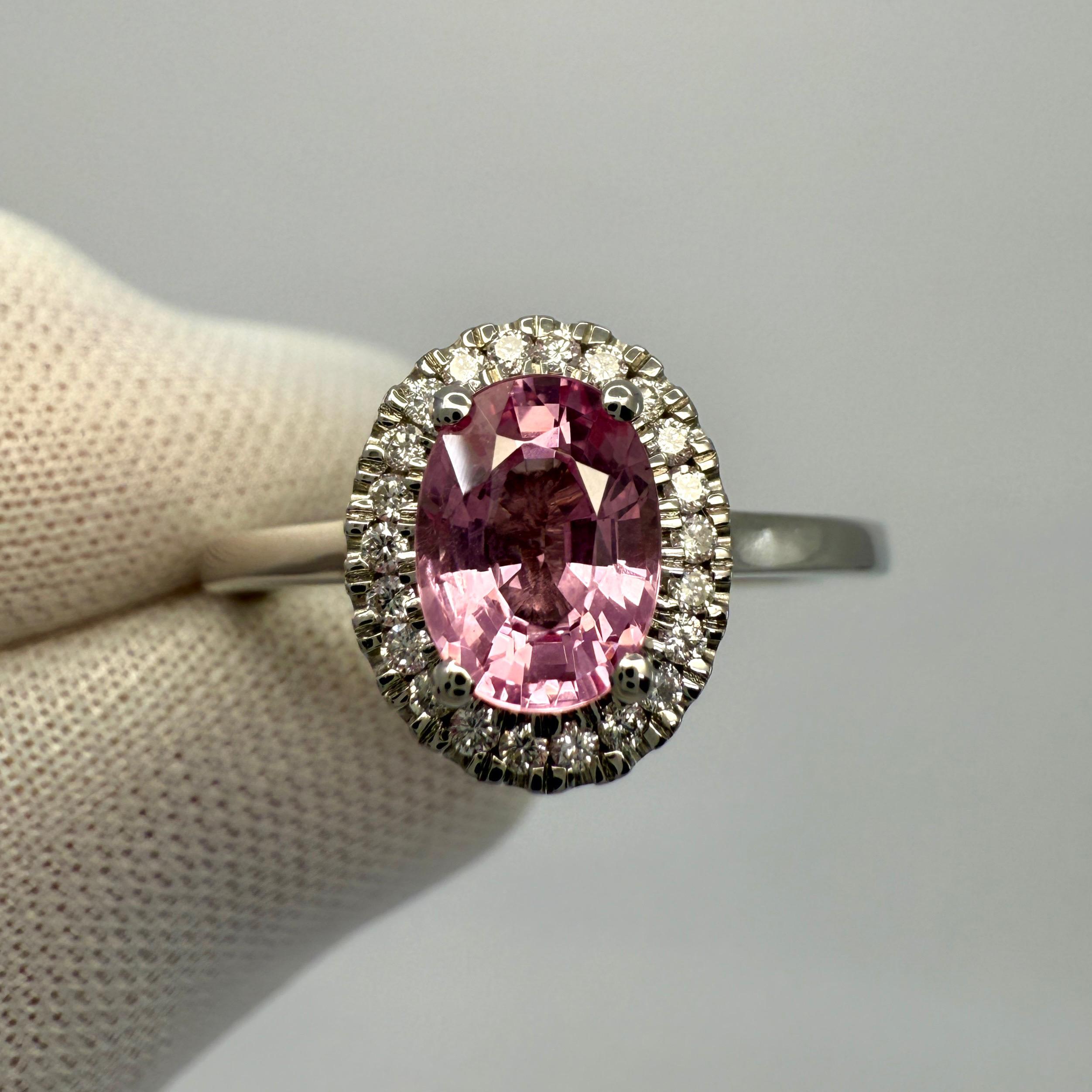 Natural Vivid Pink Mahenge Spinel And Diamond Platinum Halo Ring. 1.32 Carat total.

This beautiful ring features a 1.18ct Mahenge spinel with a stunning vivid pink colour and very good oval cut. Also has very good clarity VS, with only some very