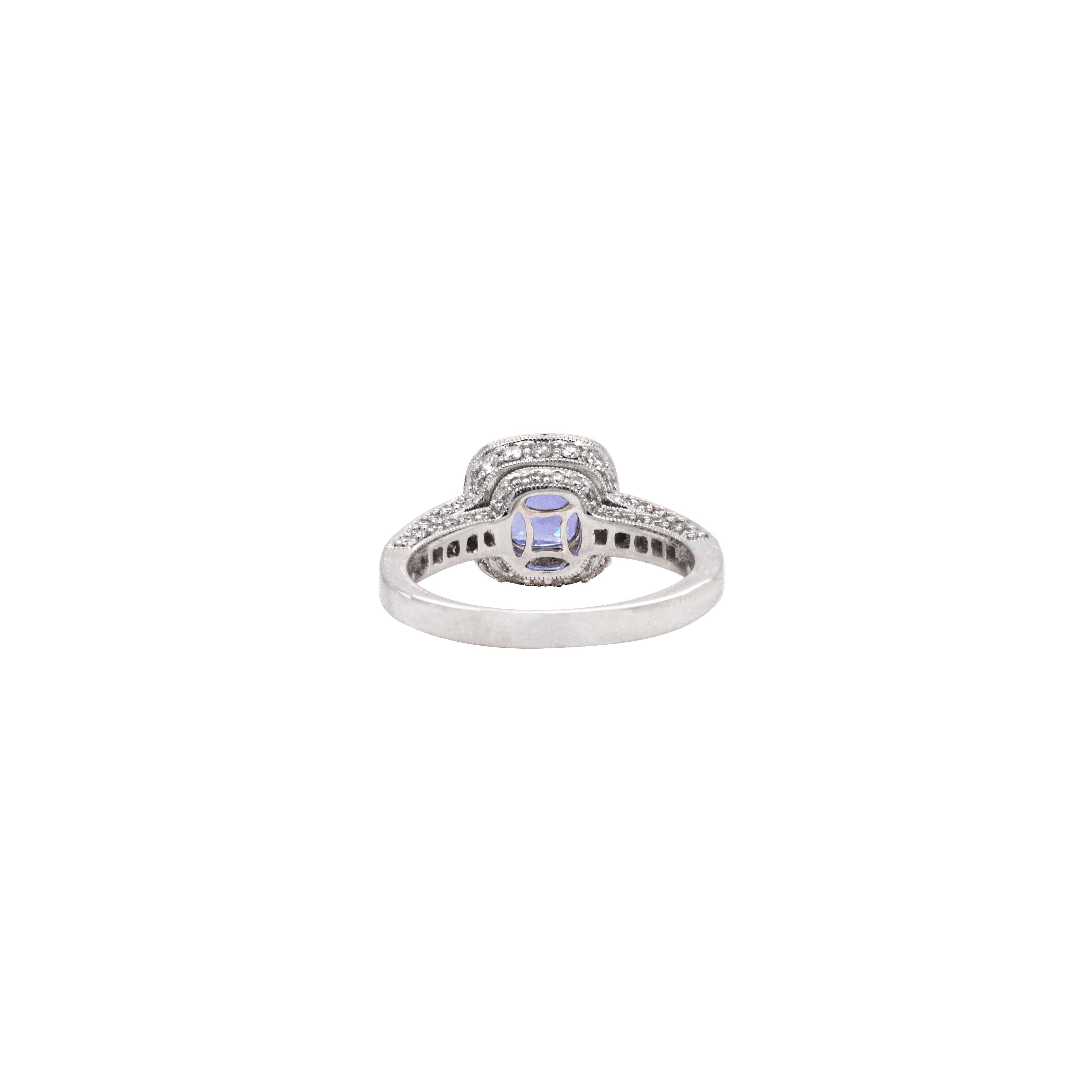 Express your commitment to a wonderful future together with this fabulous 18 carat white gold cluster engagement ring.

This fantastic ring is expertly detailed to perfection and showcases a charming 1.32ct cushion shaped tanzanite mounted in the