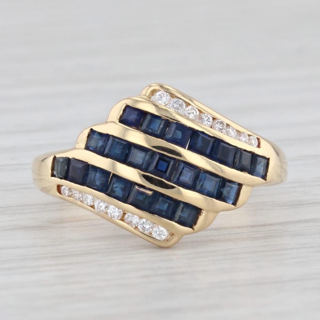 Gemstone Information:
- Natural Sapphires -
Total Carats - 1.20ctw
Cut - Square 
Color - Dark Blue
Treatment - Heated

- Natural Diamonds -
Total Carats - 0.12ctw
Cut - Round Brilliant
Color - F - G
Clarity - VS2

Metal: 18k Yellow Gold
Weight: 4.8