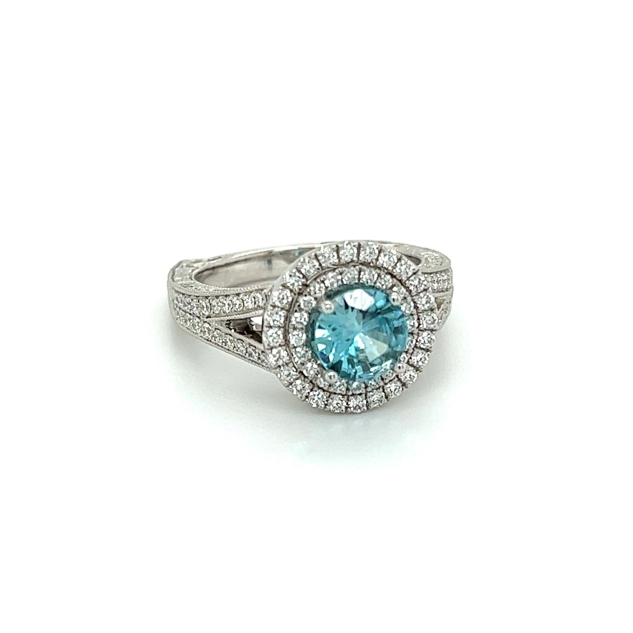 Simply Beautiful! Finely detailed Blue Zircon and Diamond Gold Cocktail Ring. Centering a securely nestled Hand set 1.33 Round Blue Zircon. Surrounded by Round Diamonds, including Fabulous European design shank weighing approx. 1.01tcw. Approx.