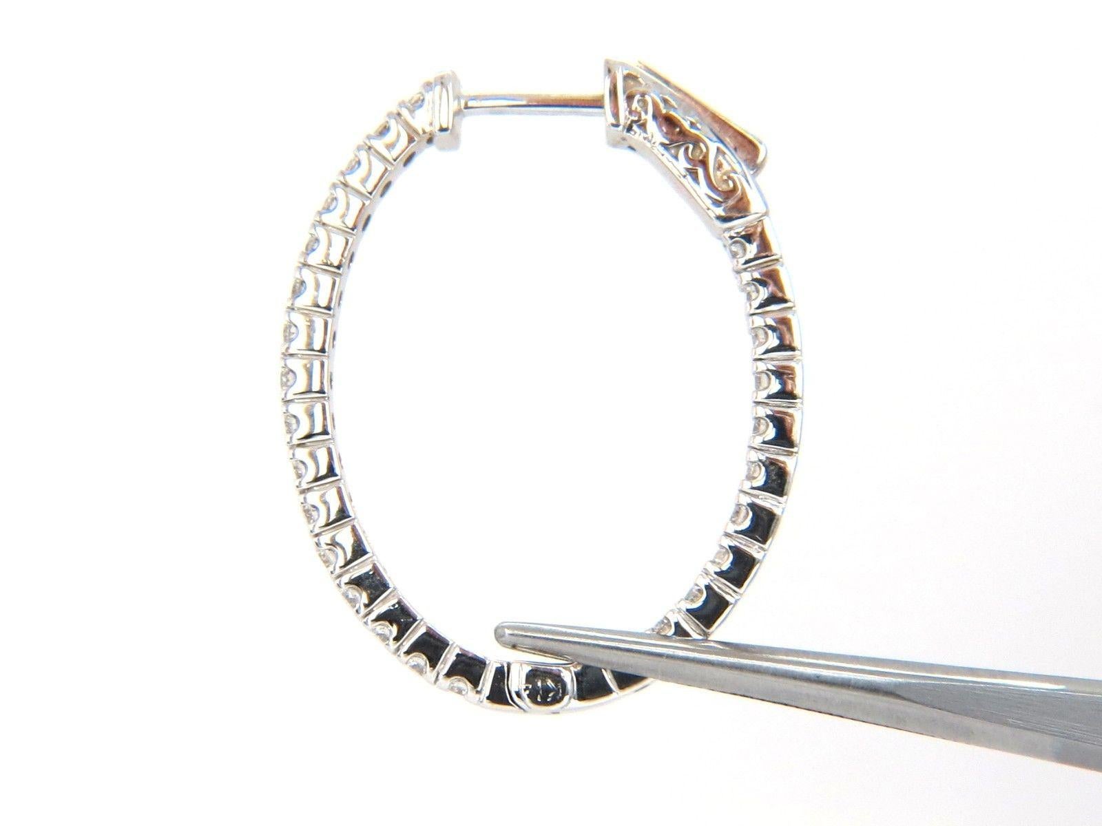 Elongated Hoop, Snap button closure & Inside out

1.33ct. Natural diamonds  

Rounds, Full cut brilliants.

G- color Vs-2 Clarity. 

Excellent detail.

14kt. white gold

6.5 grams.

.91 inch wide

1.15  inch long

2.00mm long

$3800 Appraisal