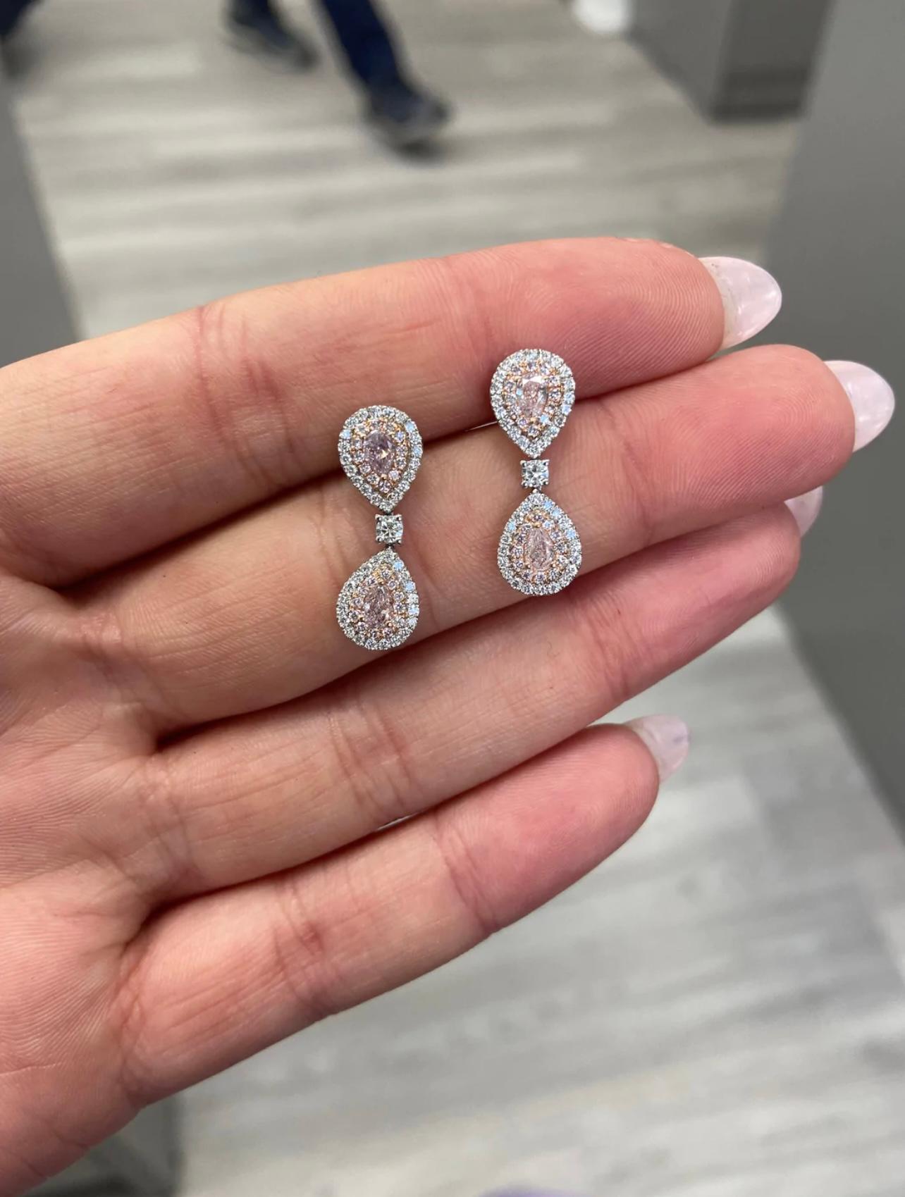 Natural Light Pink Diamond earrings
4 Pear Shapes
VS-SI1 Clarity 
Handset in 18k White Gold 
Double pink and white diamond halo 
1.20 total diamond carat weight
