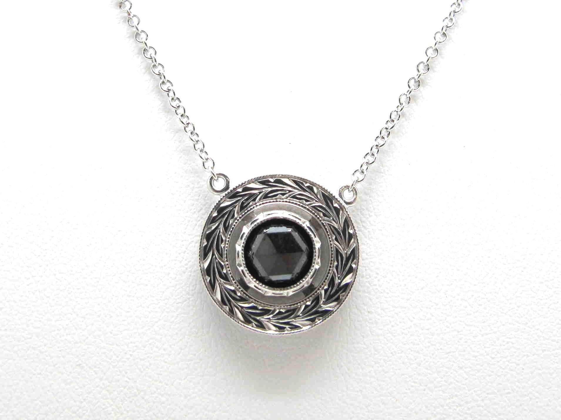 This dramatic rose cut black diamond and white gold necklace will have you ready for any occasion! The black diamond is set in a beautiful 18k white gold, hand engraved bezel as part of our signature Day and Night Collection. Handcrafted by our