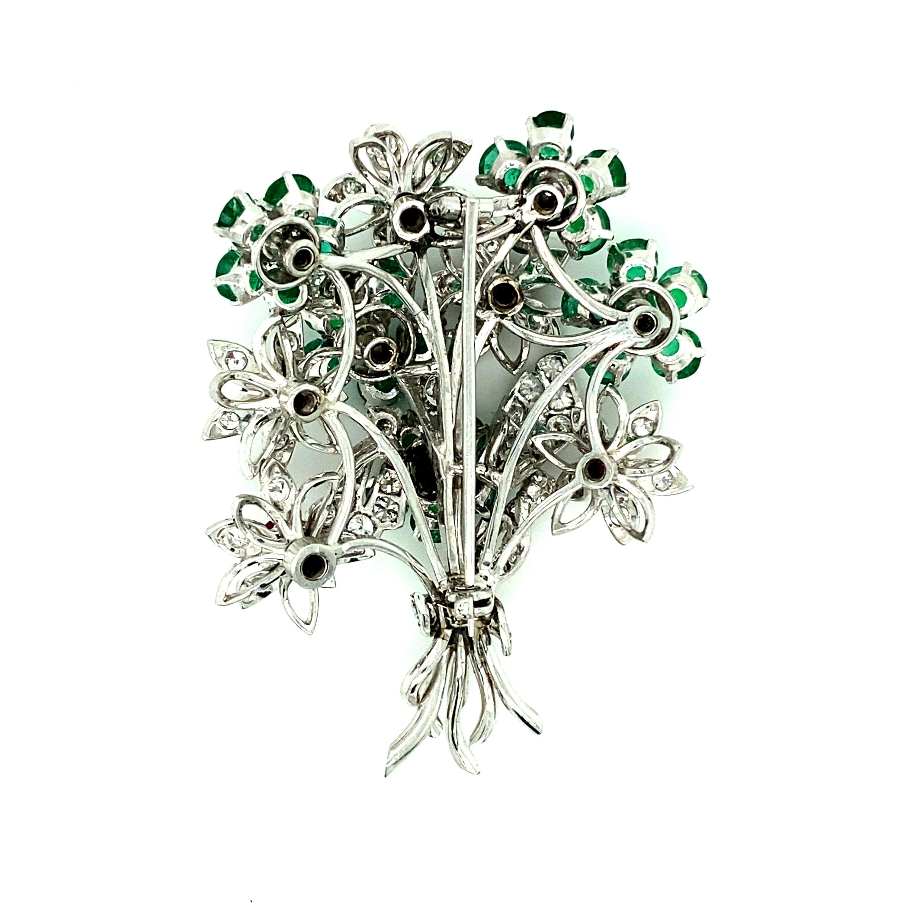Offered here is a beautiful 13.30 ct Ruby, Emerald and Diamond Platinum Flower Brooch. 
Diamonds: natural round brilliant cut diamonds with an estimated total weight of 8.00ct. 
Ruby & Emerald: 25 natural round brilliant cut Emerald’s and 5 natural