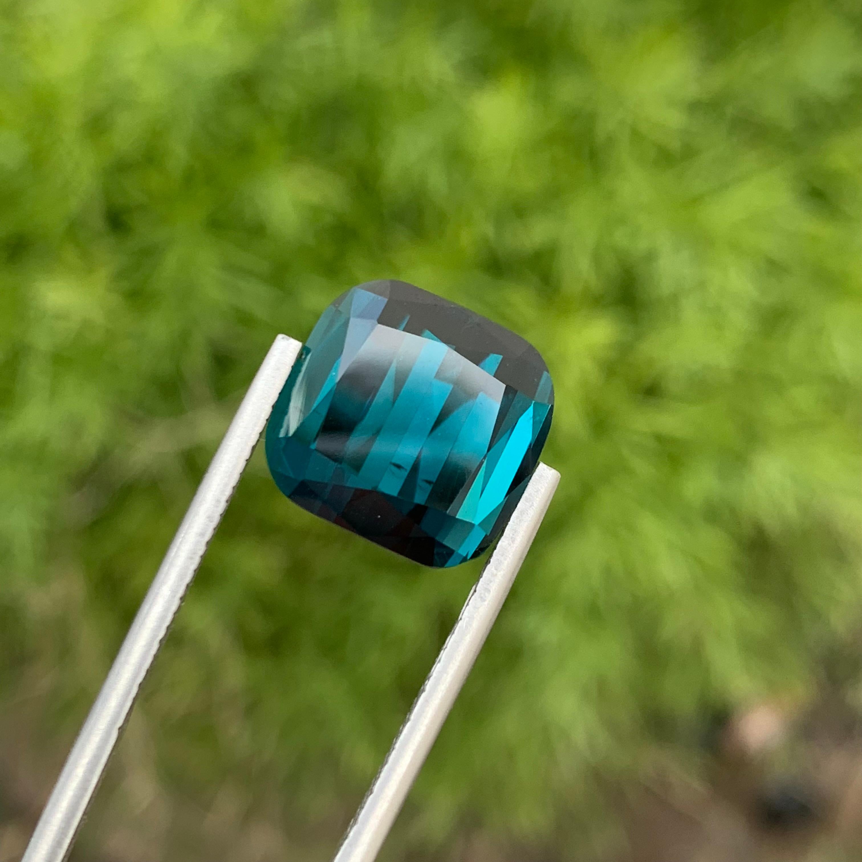 Loose Indicolite Tourmaline 
Weight: 13.35 Carats 
Dimension: 12.9 x 12.4 x 9.8 Mm 
Origin: Kunar, Afghanistan 
Treatment: Non 
Colour: Deep Blue 
Shape : Cushion 
Certificate: On Demand 
Indicolite is a captivating variety of tourmaline, renowned