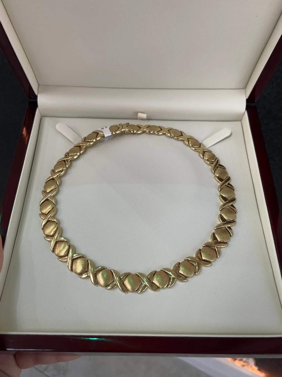 Featured is a classic, elegant, 17-inch gold necklace. This remarkable piece makes a statement anywhere that you may take it. It is crafted in solid 14K yellow gold with a unique 
